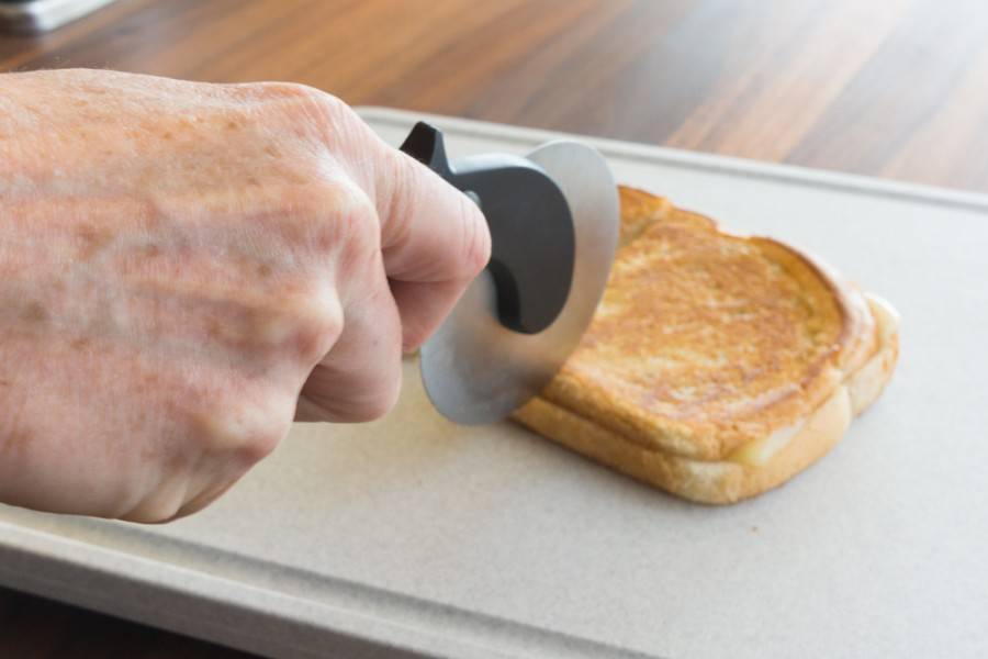 Cutting grilled cheese with the Pizza Cutter.