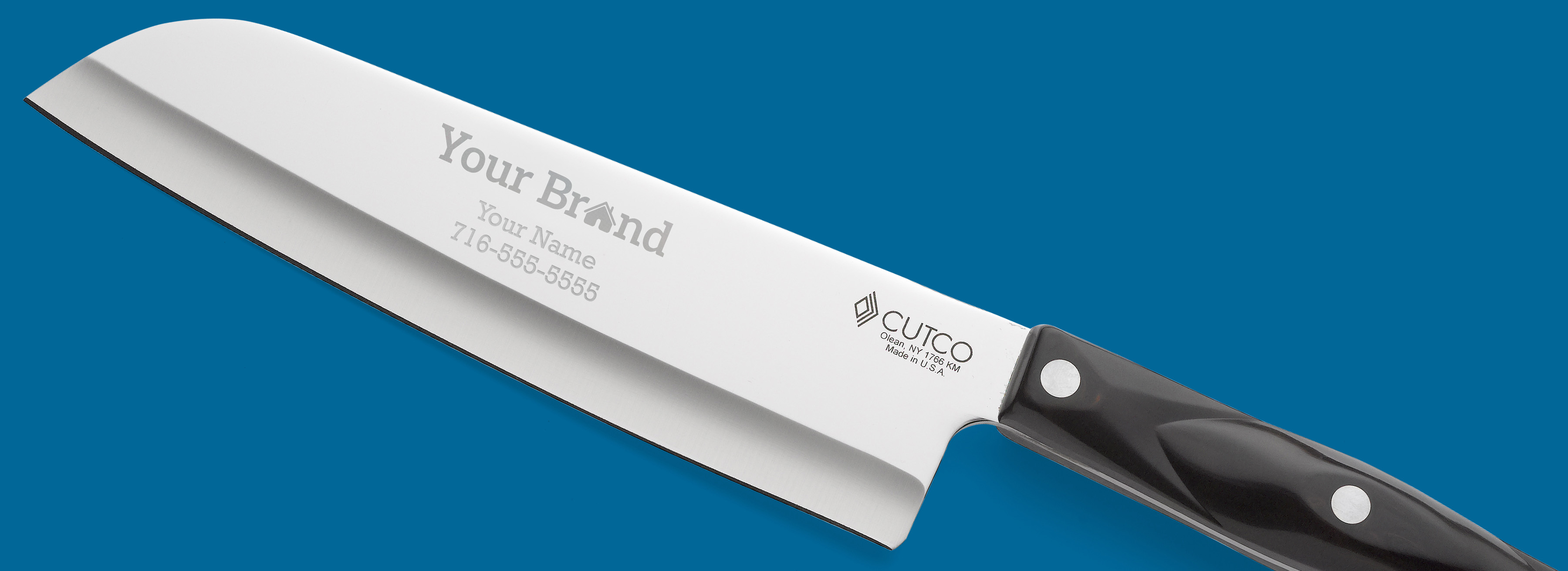 A cutco knife with the ReMax logo, name and phone number engraved on the blade.