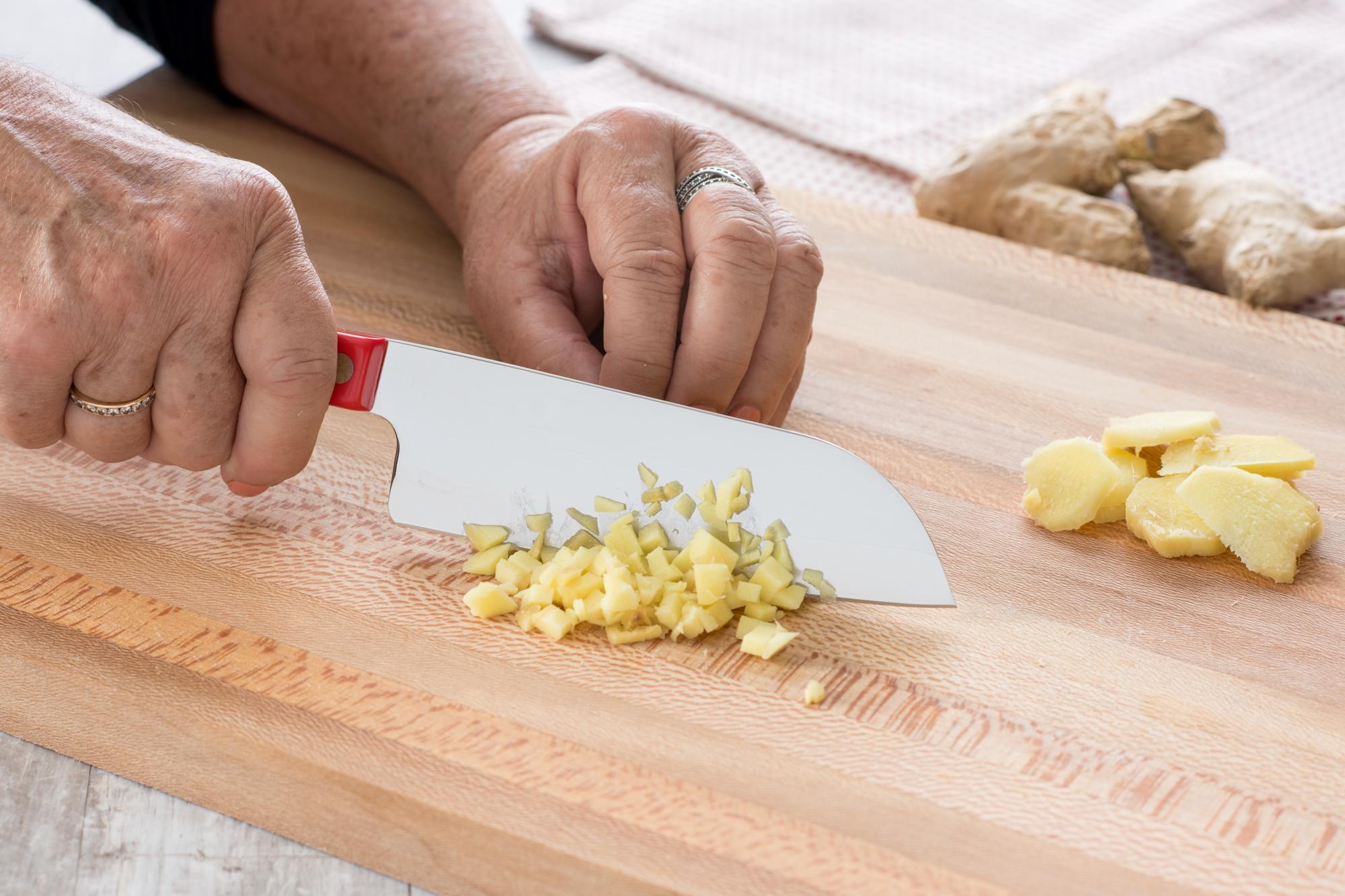 Using a Petite Santoku to mince ginger.