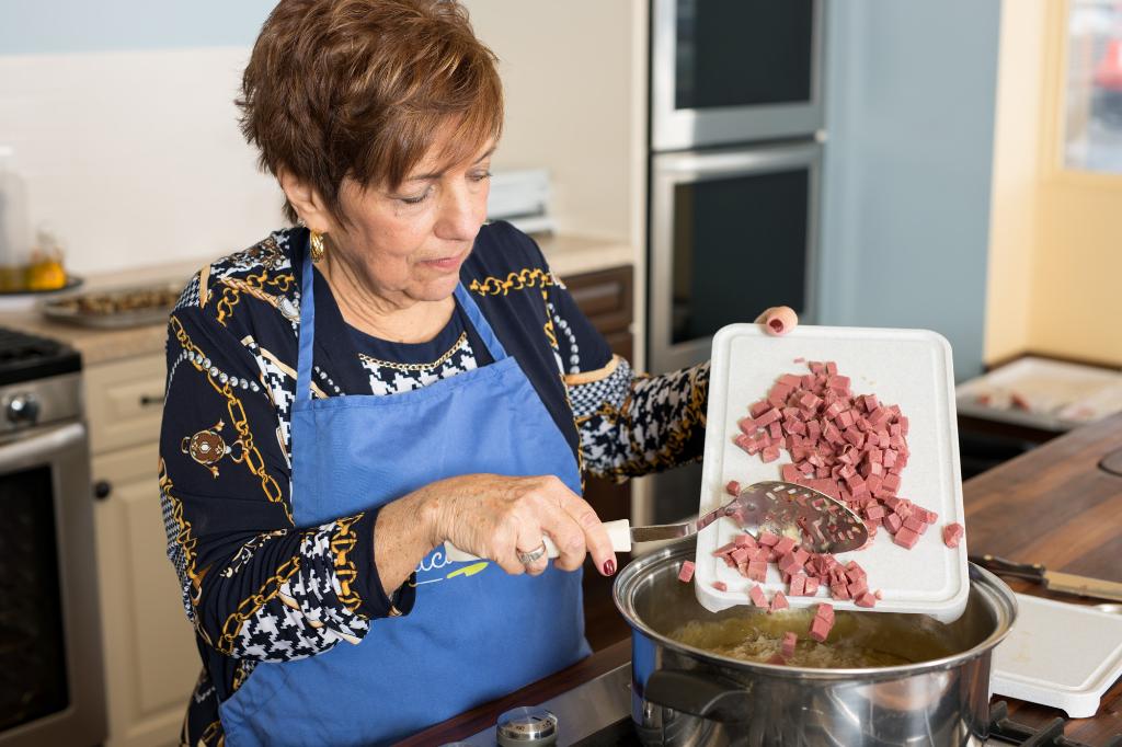 Using a Slotted Spoon to add the meat.