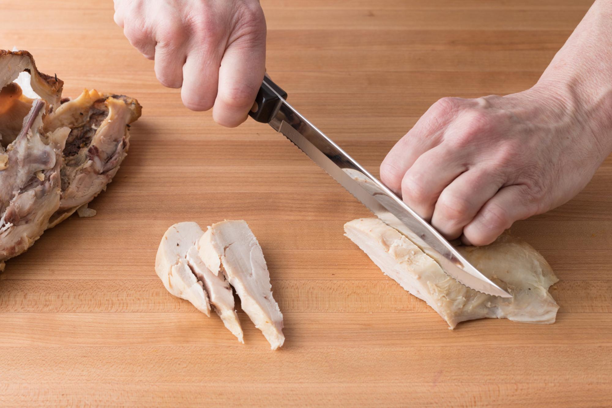 Slicing the chicken.