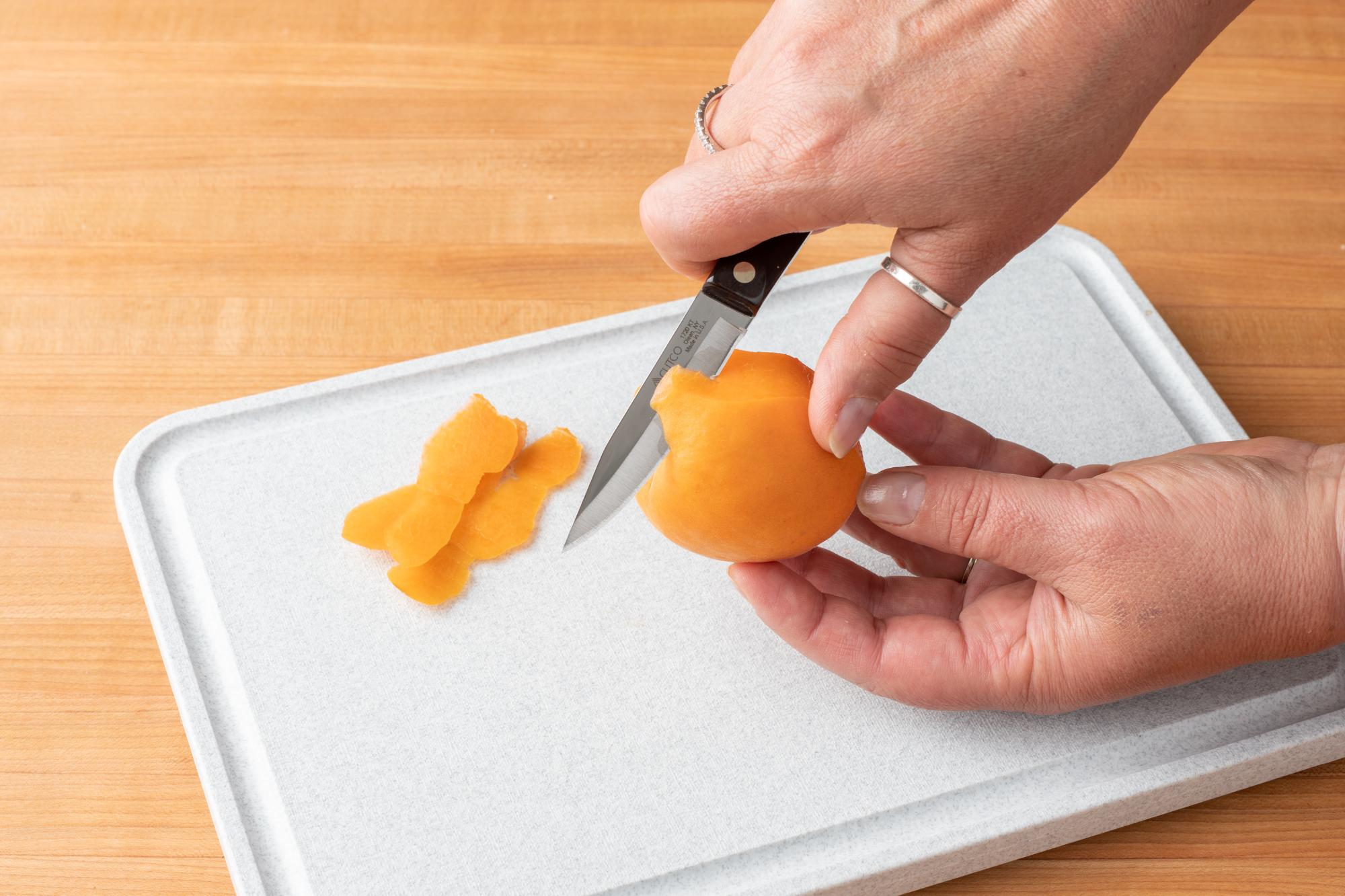 The smaller paring knife is perfect for peeling the apricot.