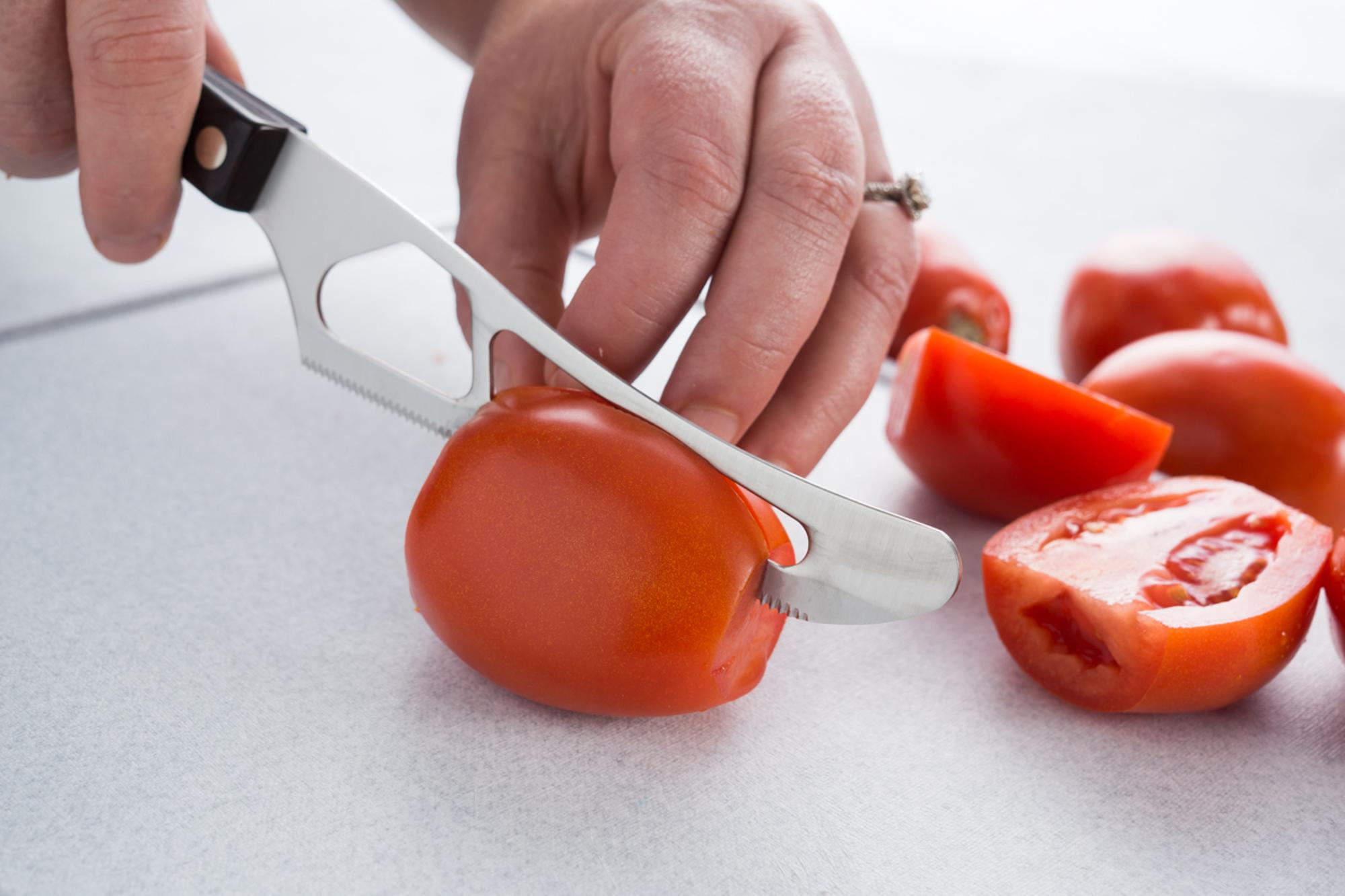 Cutting tomatoes into wedges with a Traditional Cheese Knife.