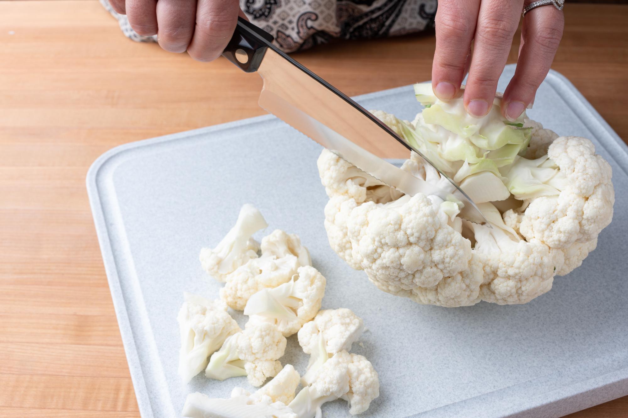 Using a Gourmet Prep knife to cut the cauliflower.