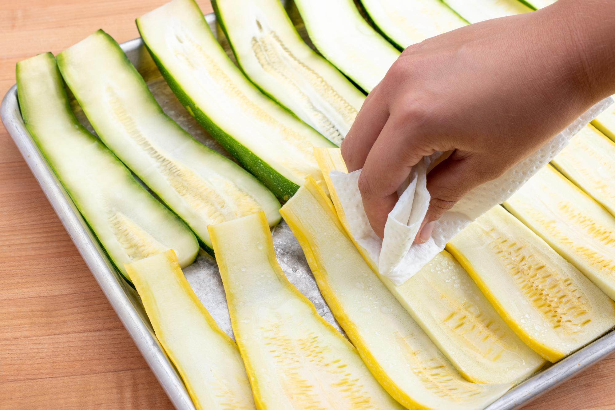 Wiping away the moisture with a paper towel.