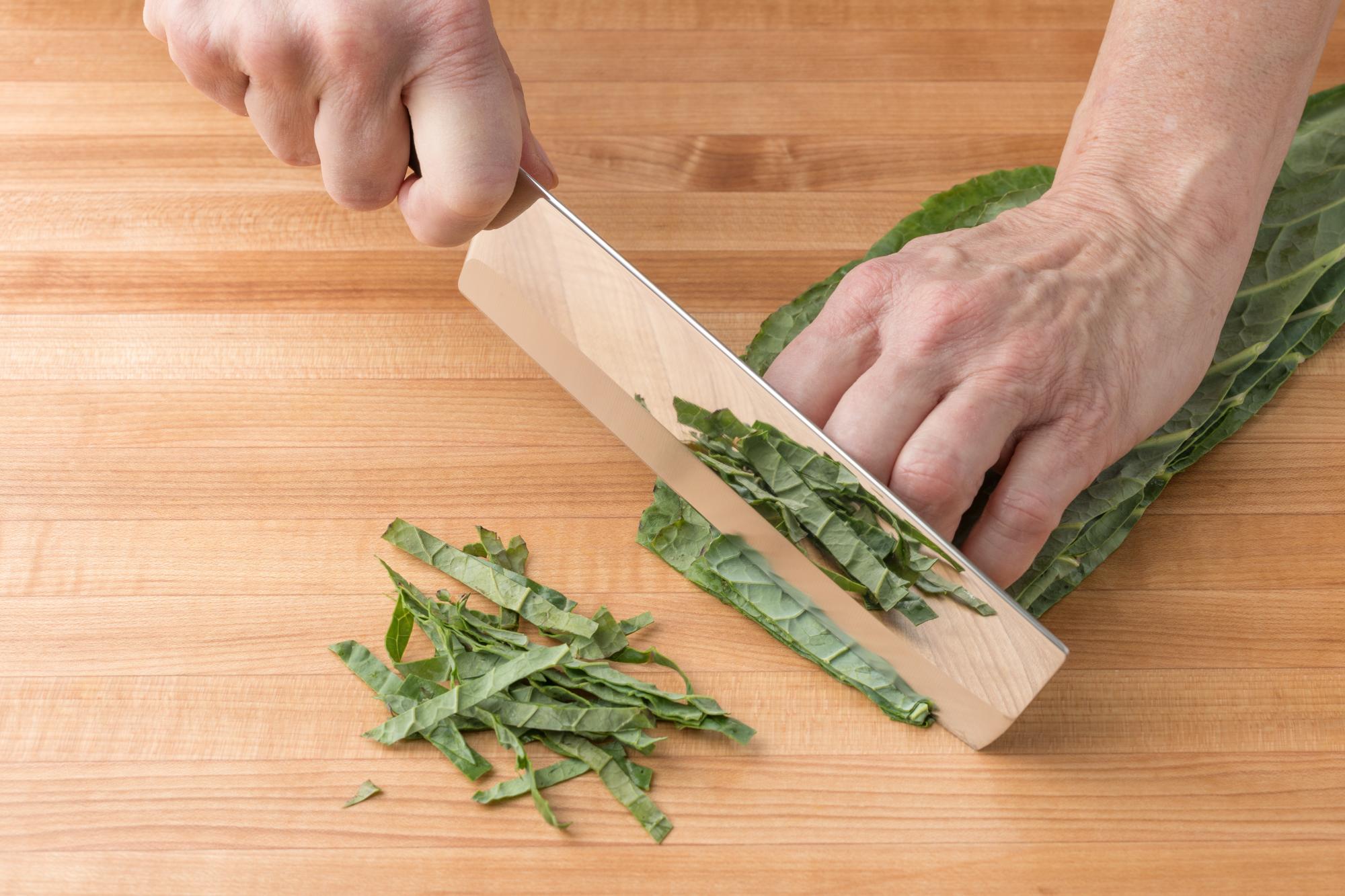 Slicing collard greens with a Vegetable Knife.