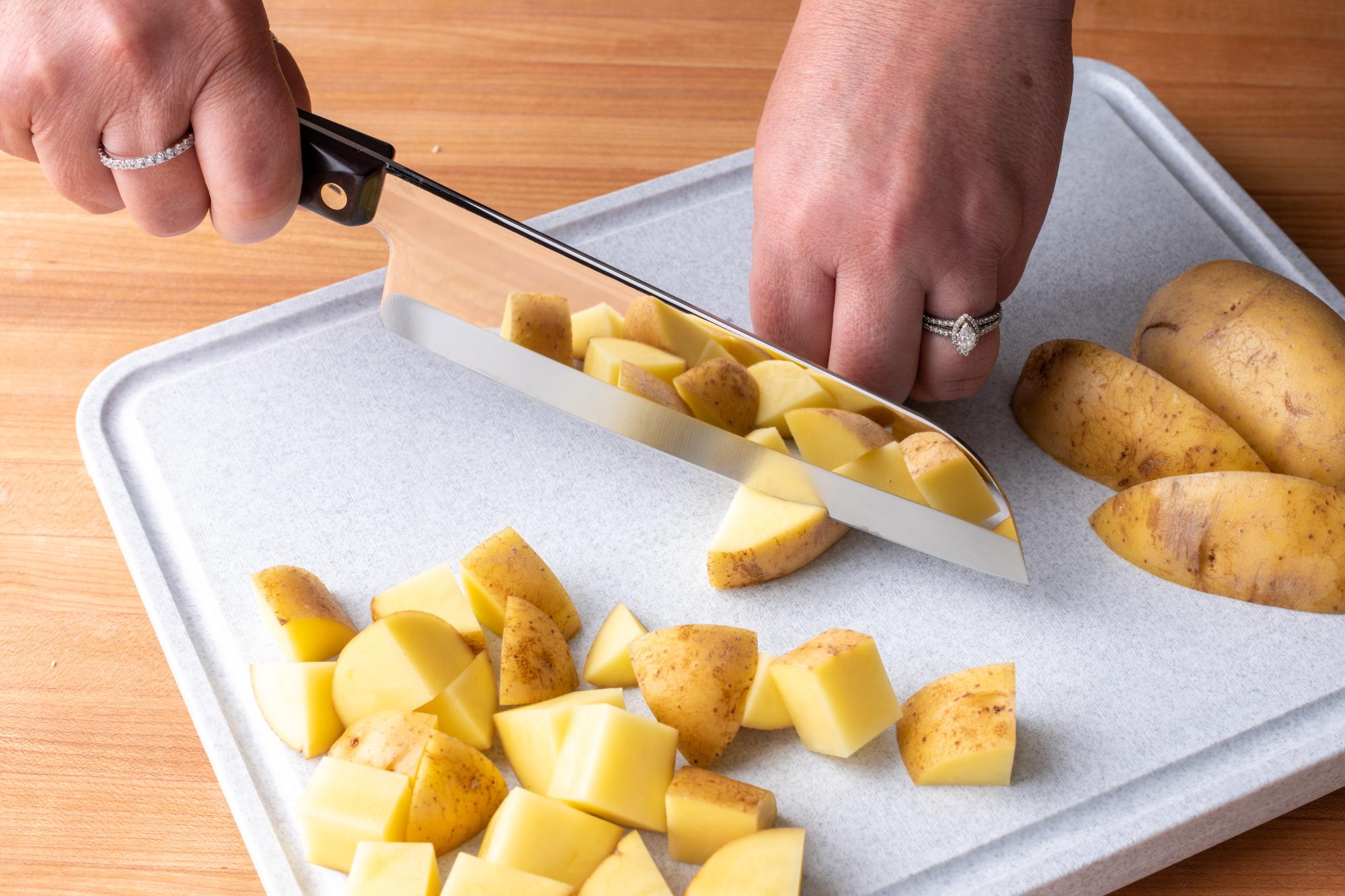 Using the 7 inch Santoku to chop up the potatoes.