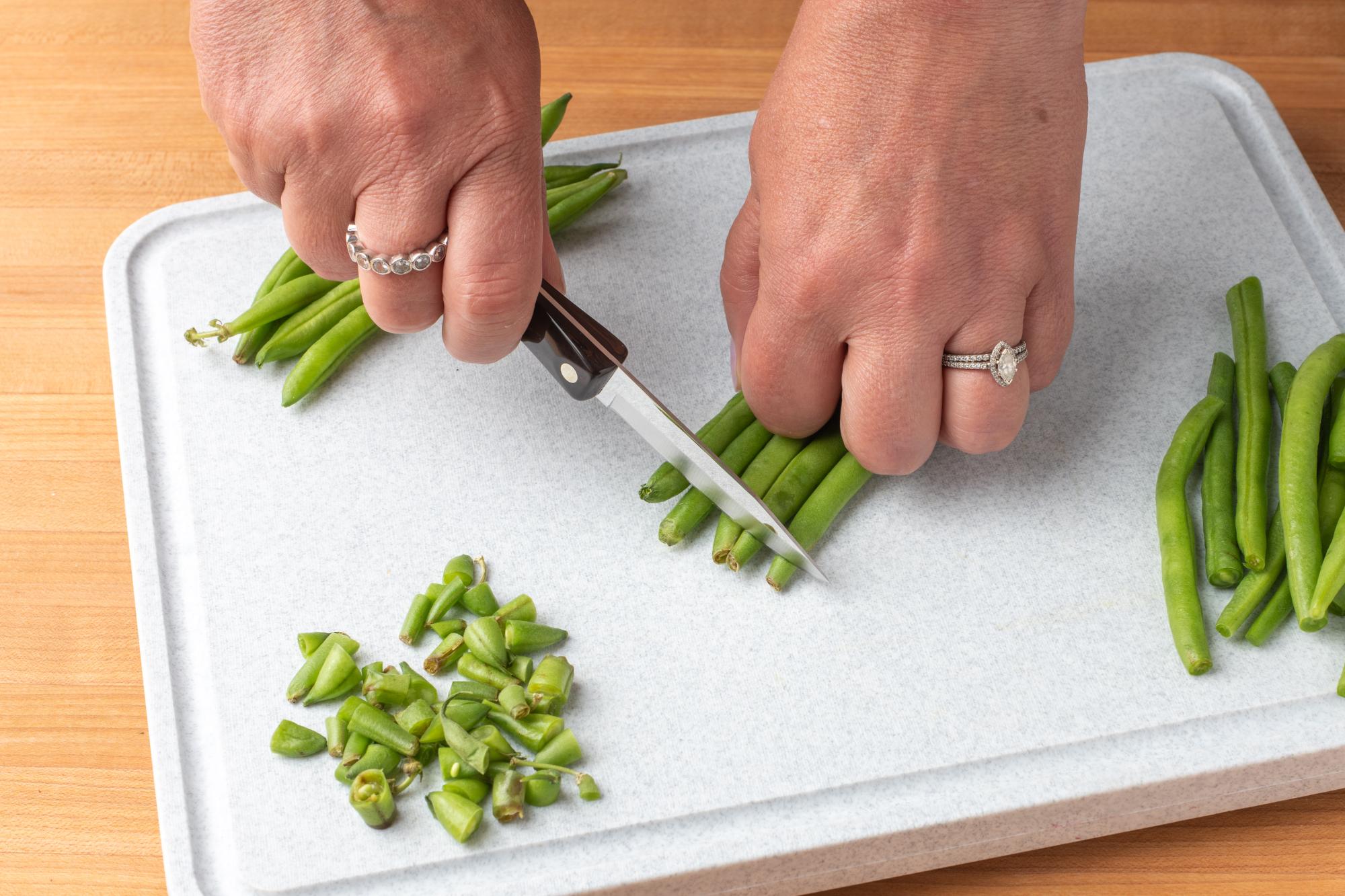 Trimming ends off the green beans.