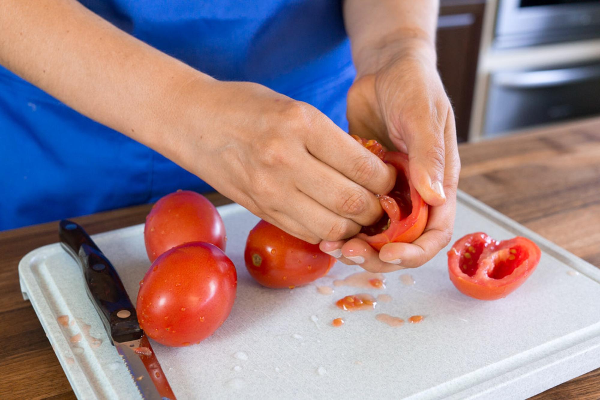removing the seeds from plum tomatoes.