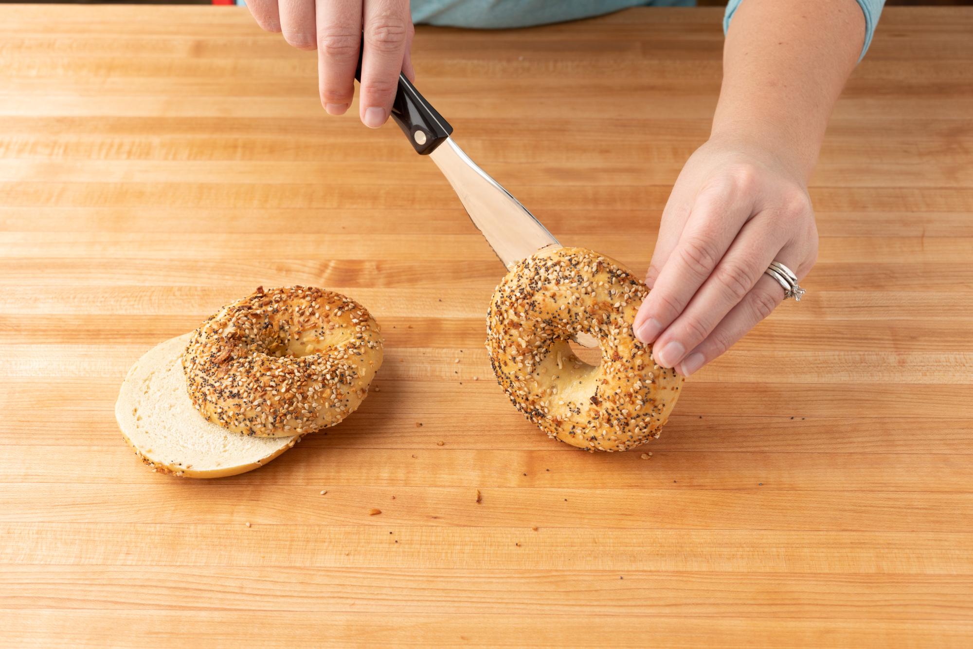 Using the Spatula Spreader to slice the bagel in half.