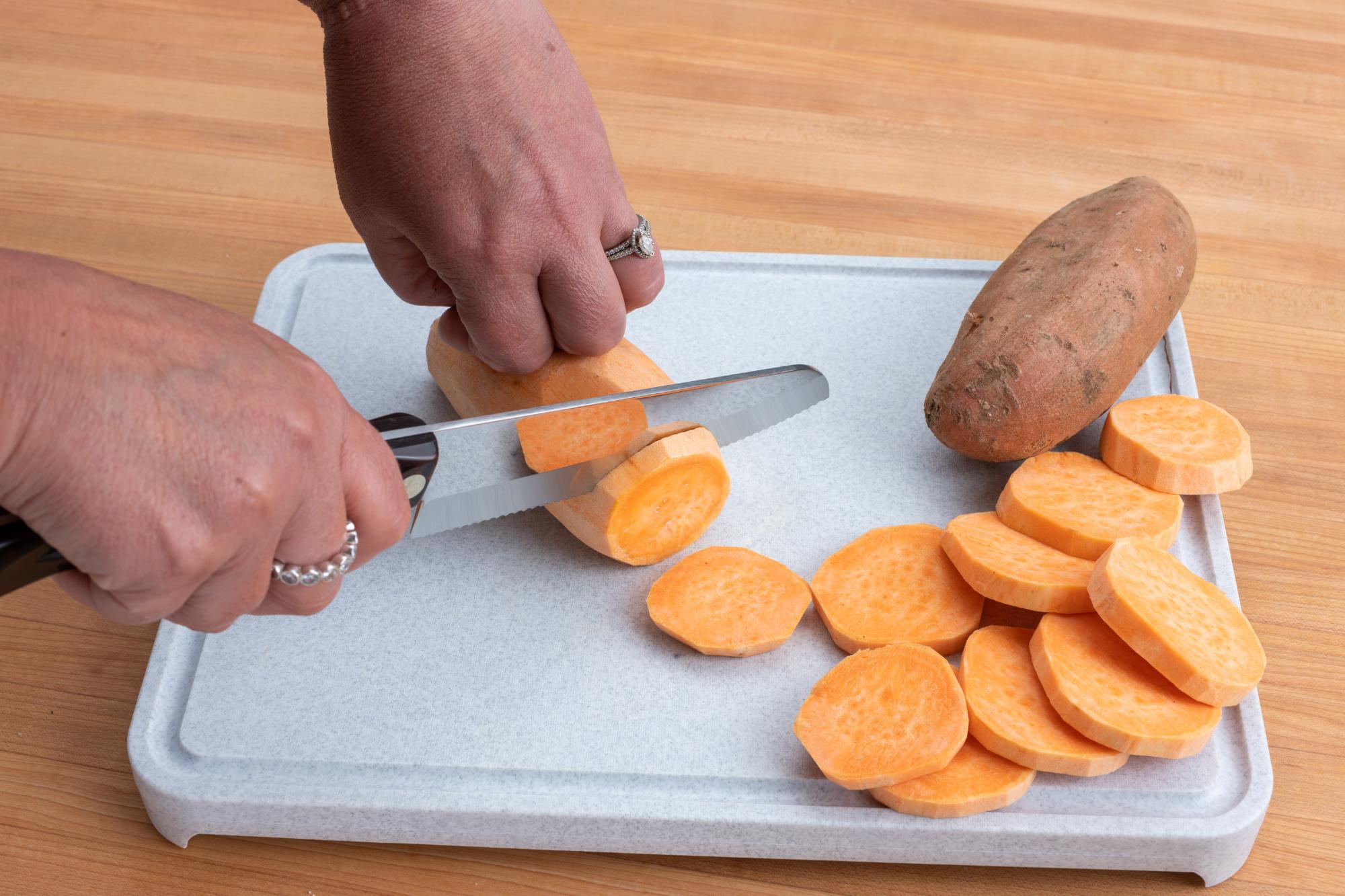 Making slices of sweet potato with the Hardy Slicer.