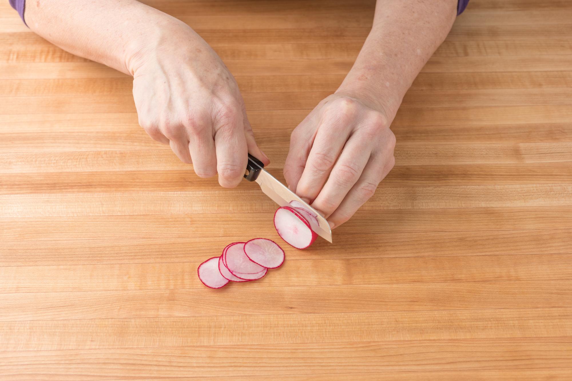 Using a Santoku-Style Paring Knife to thinly slice the radish.