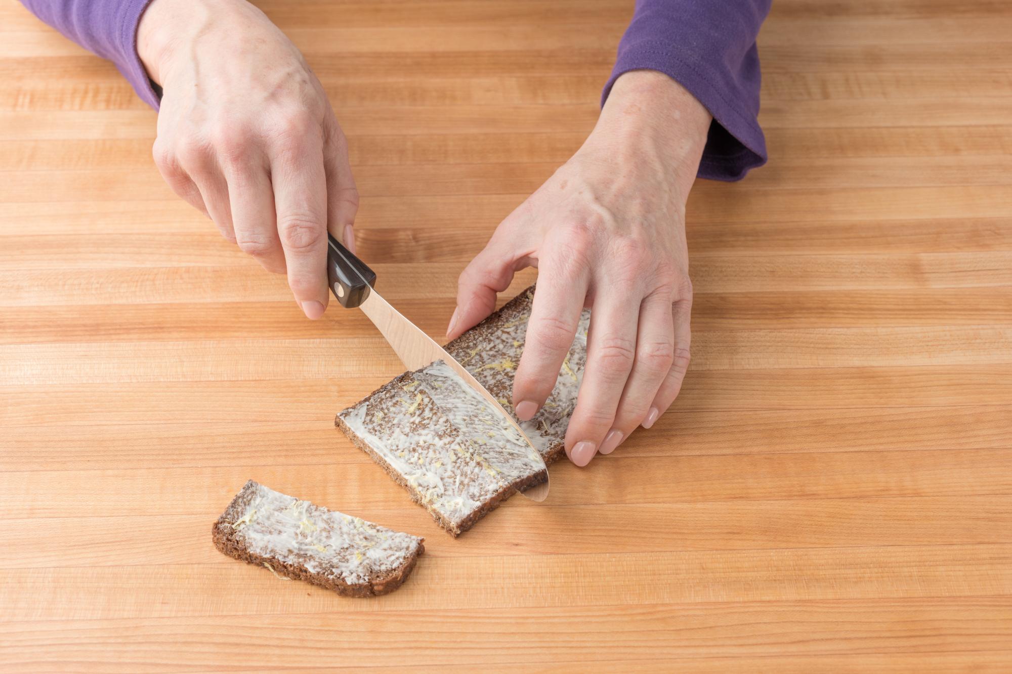 Using a Spatula spreader to cut the bread into appropriately sized slices