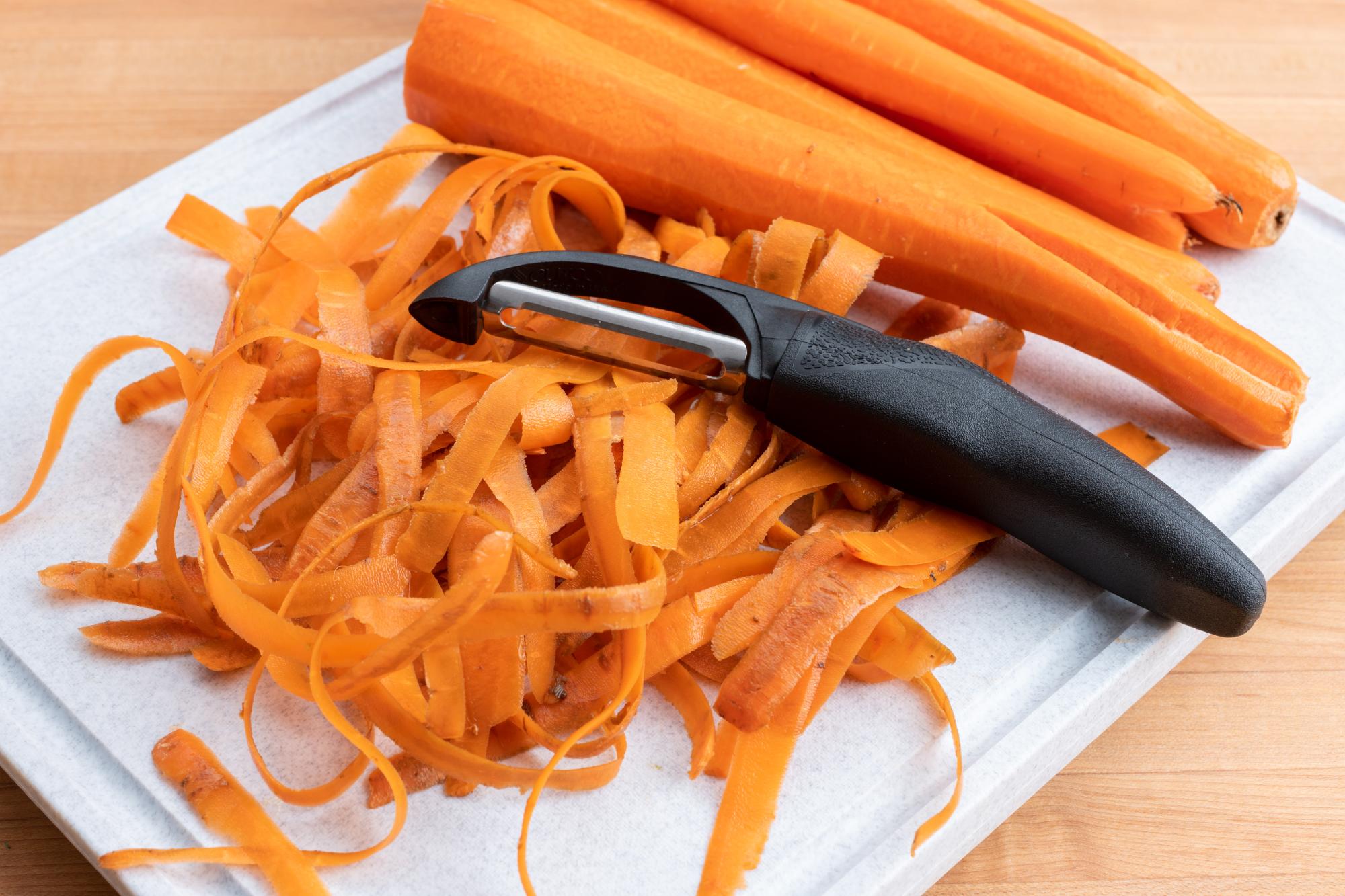 quickly peel the carrots with the Cutco Vegetable Peeler.