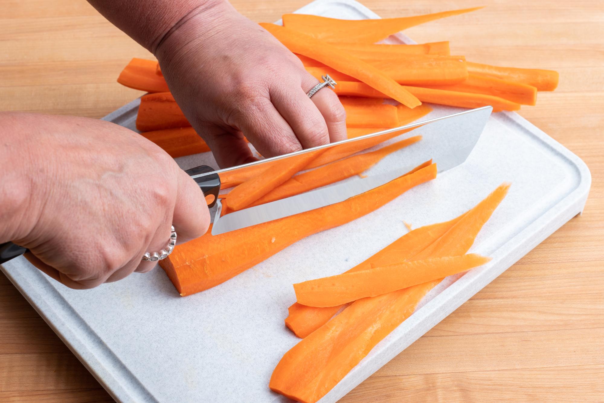 using a Vegetable Knife to cut the carrots into planks