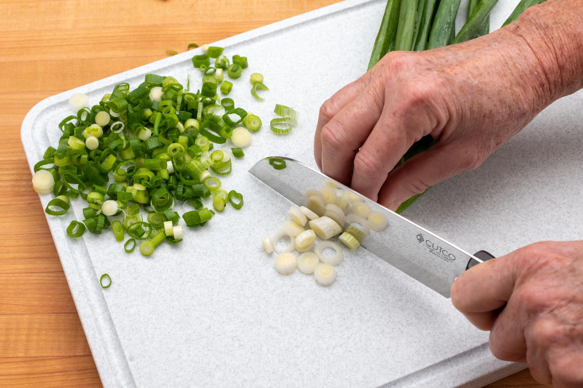 Using the Petite Santoku to make small slices of green onion.