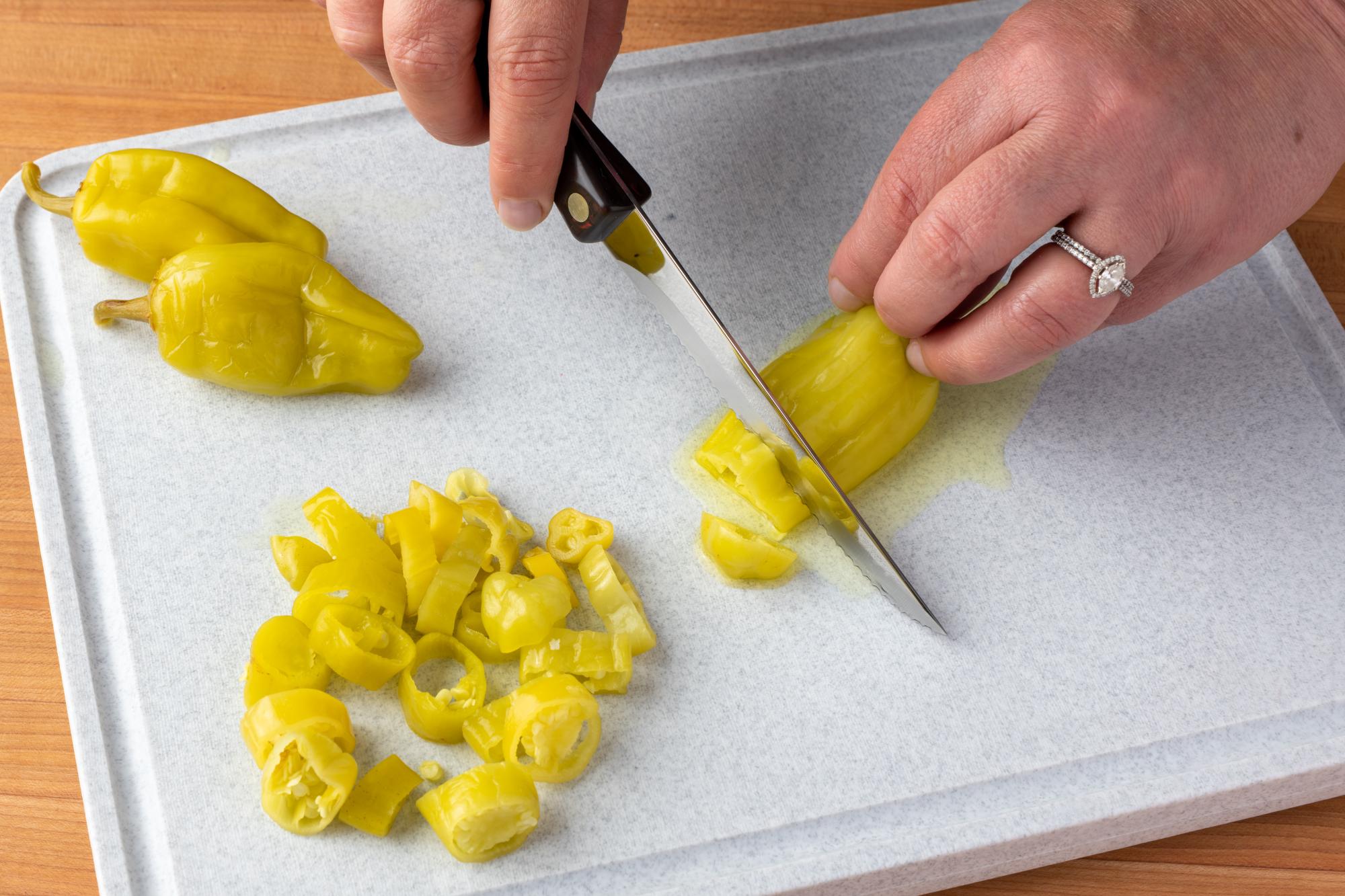 Trimmer being used to slice the pepperoncini's.