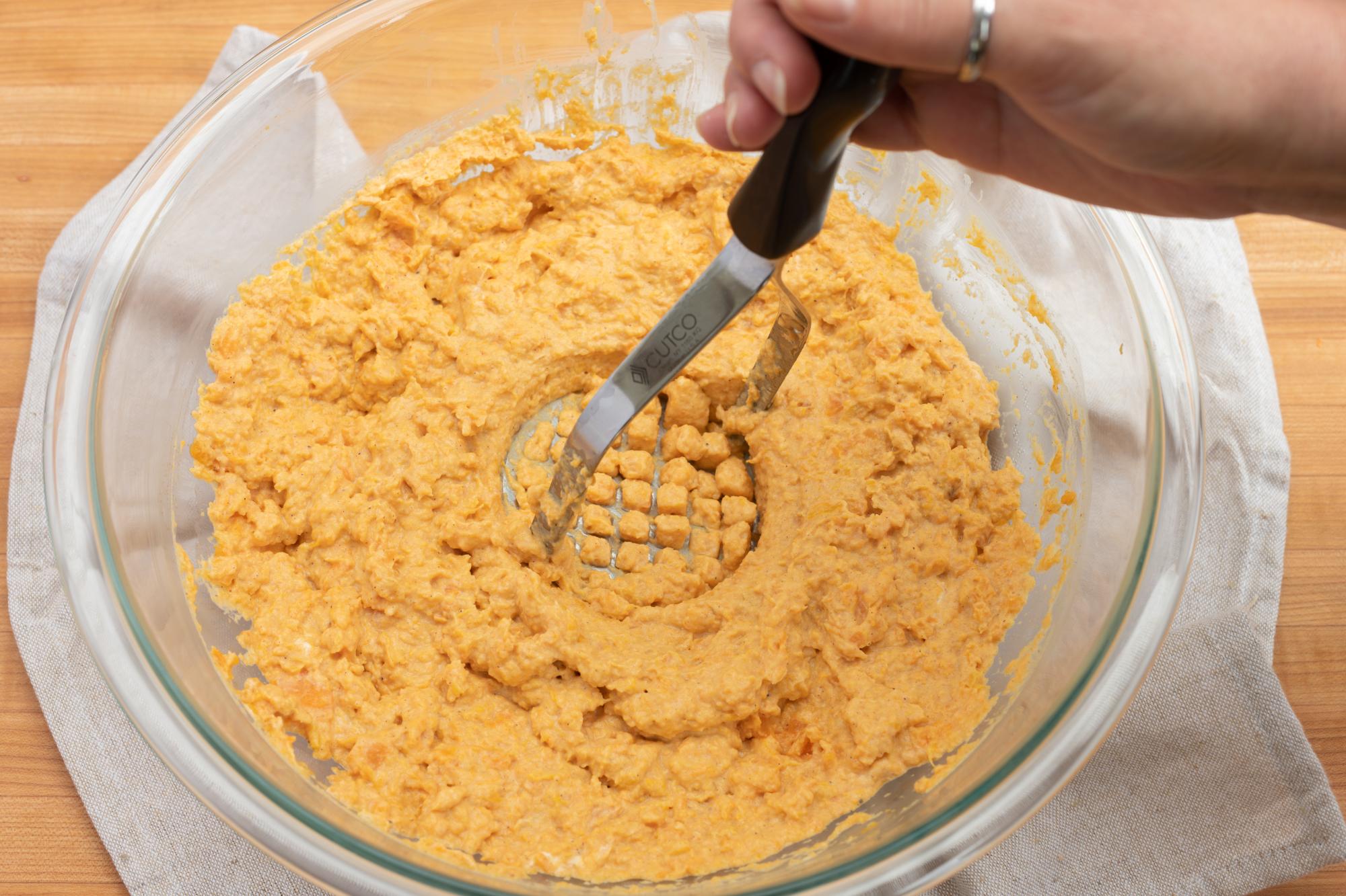 Using the Potato Masher to mash the ingredients.