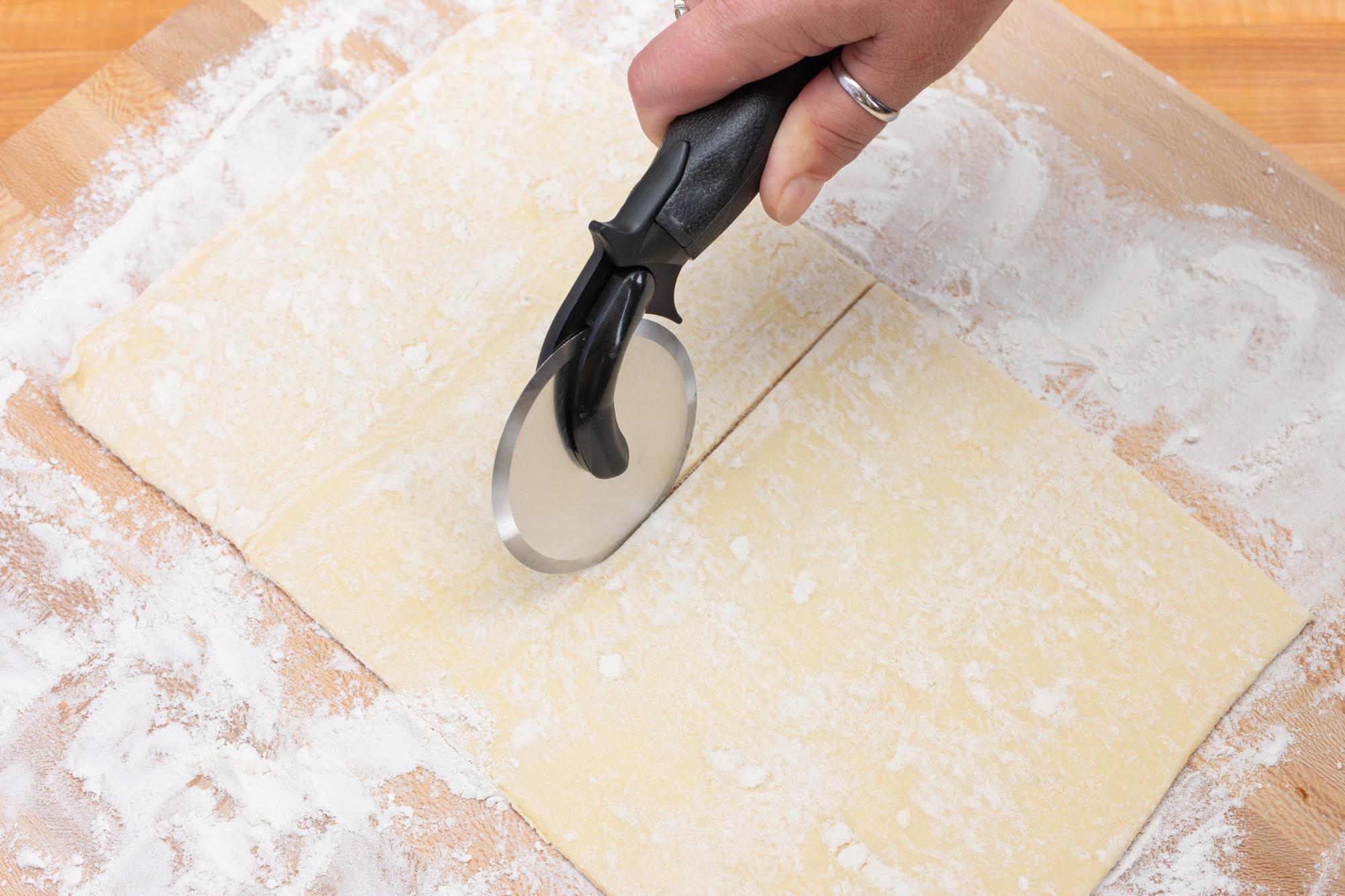 Using a Pizza Cutter to cut the puff pastry.