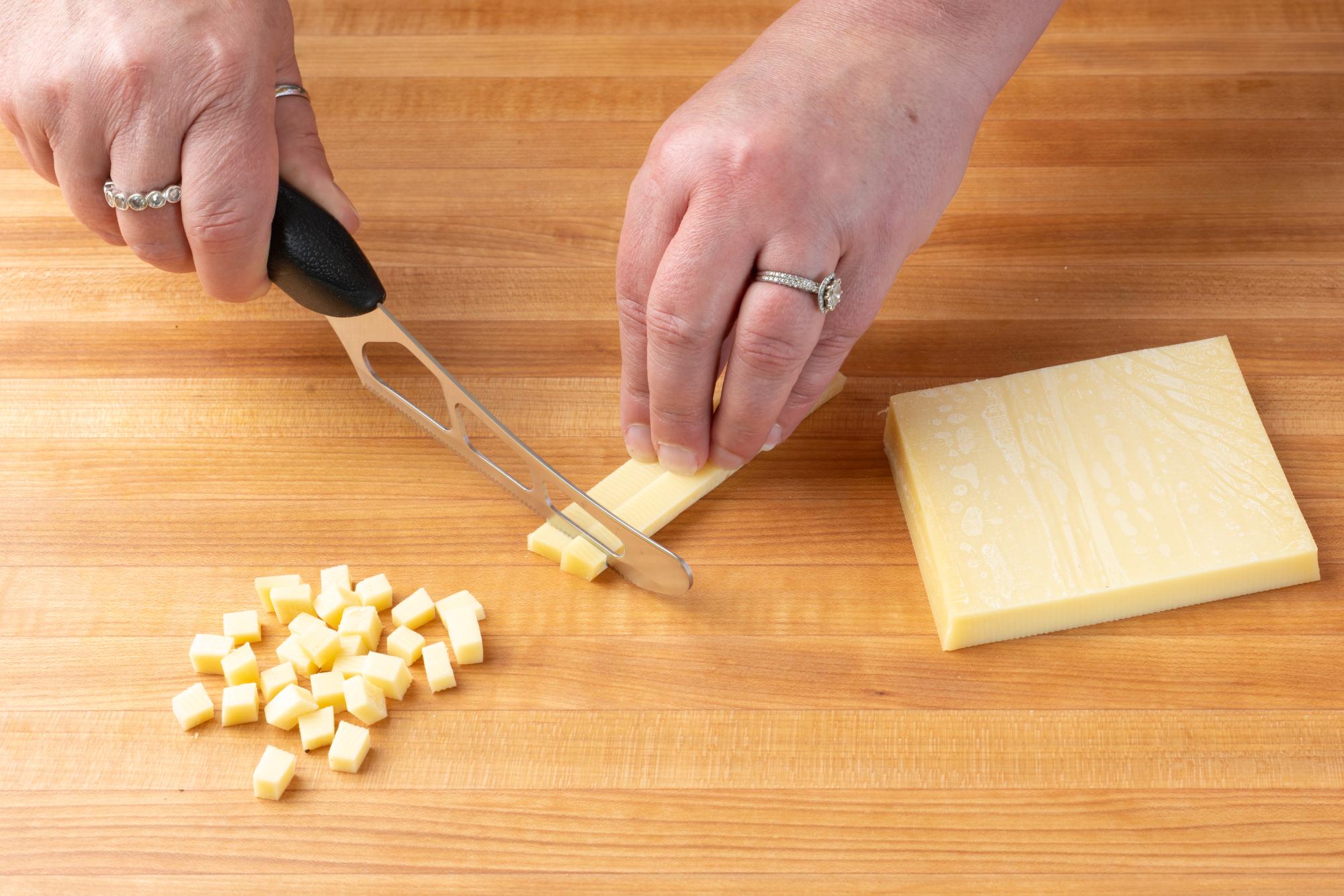 Cube the Gruyere cheese using a Cheese Knife.
