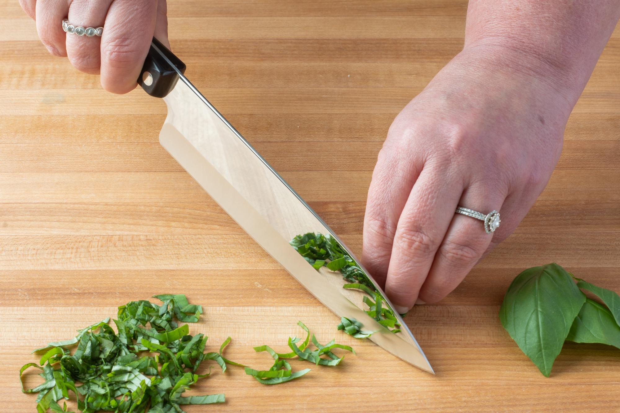 Using the Petite Chef to chiffonade the basil.