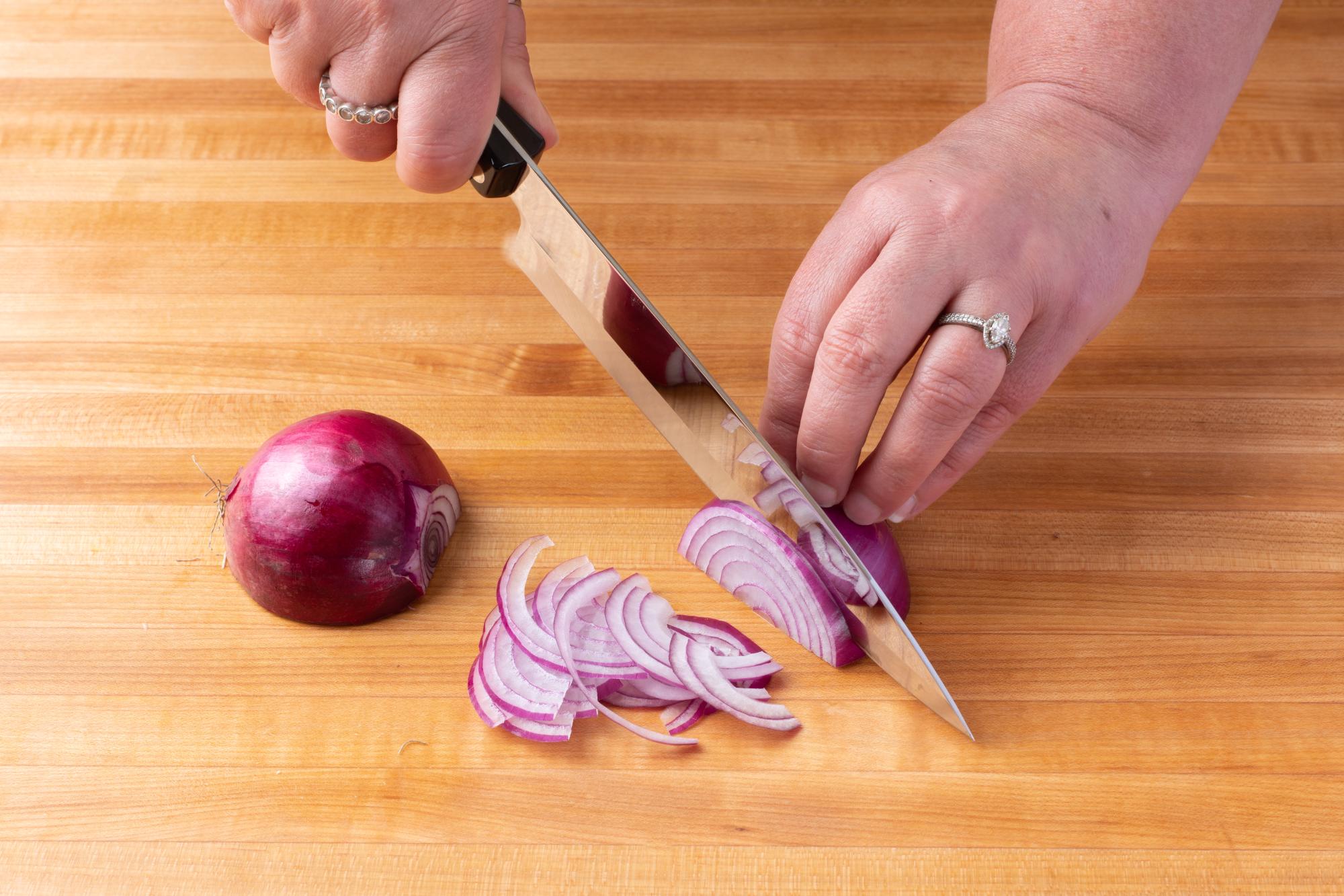 Thinly slicing the red onion with a Petite Chef.