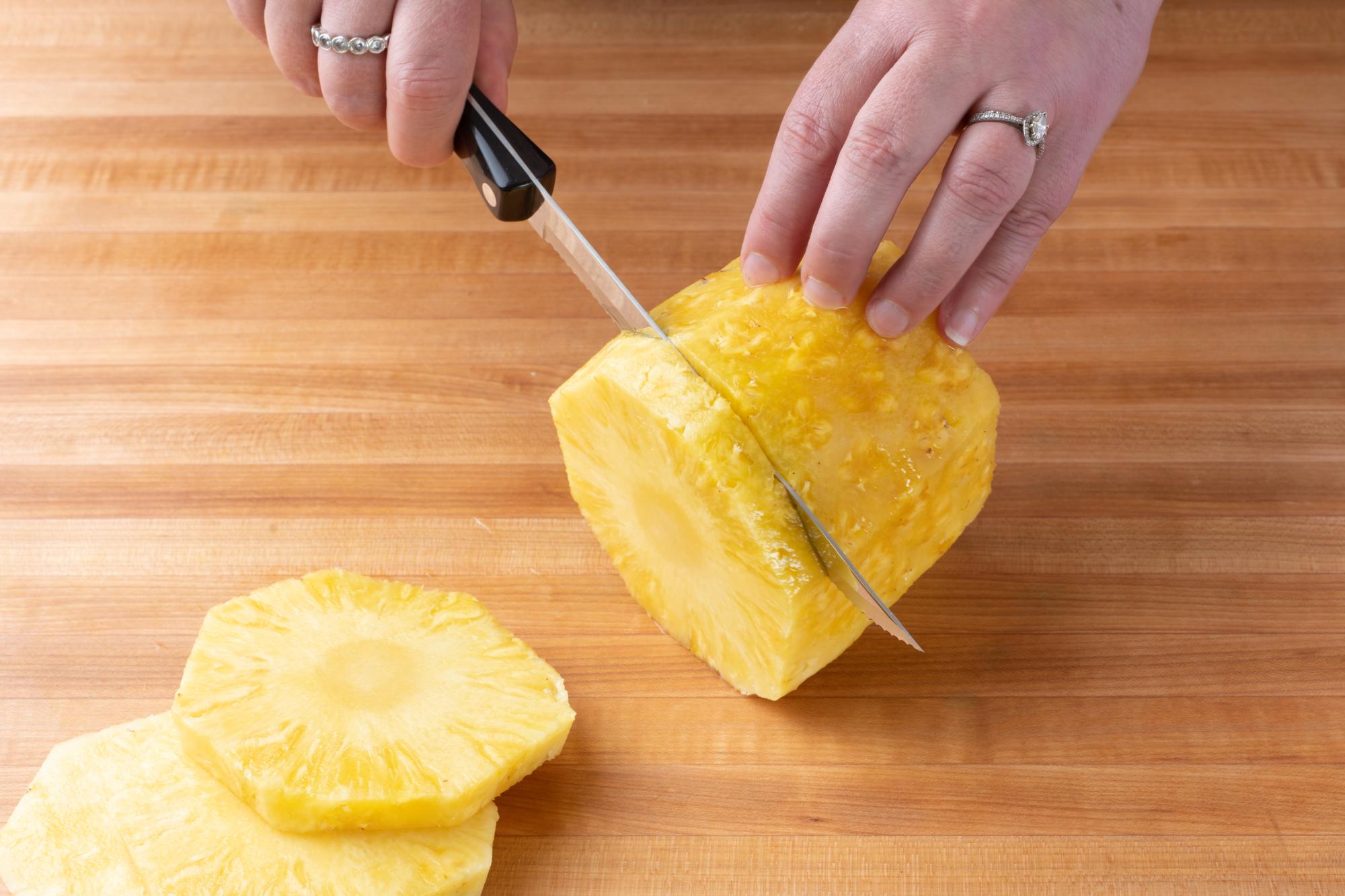 Slicing the pineapple with a Petite Carver.