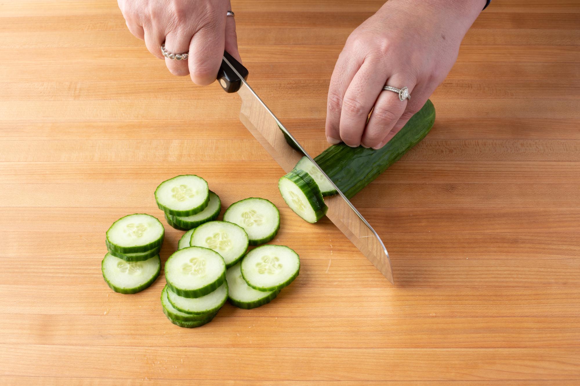 Slicing cucumber with a Santoku.
