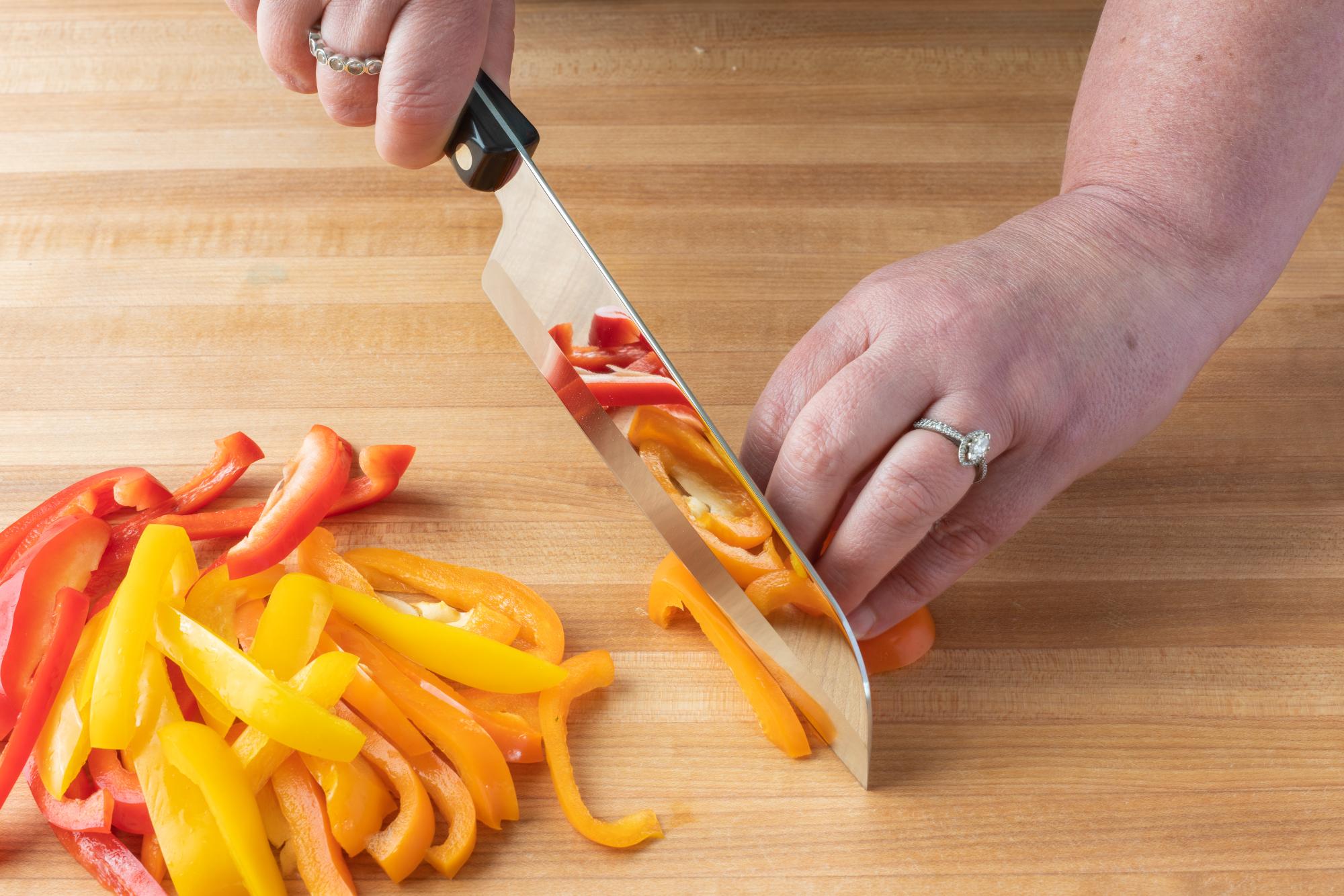 Slicing the peppers with a Santoku.