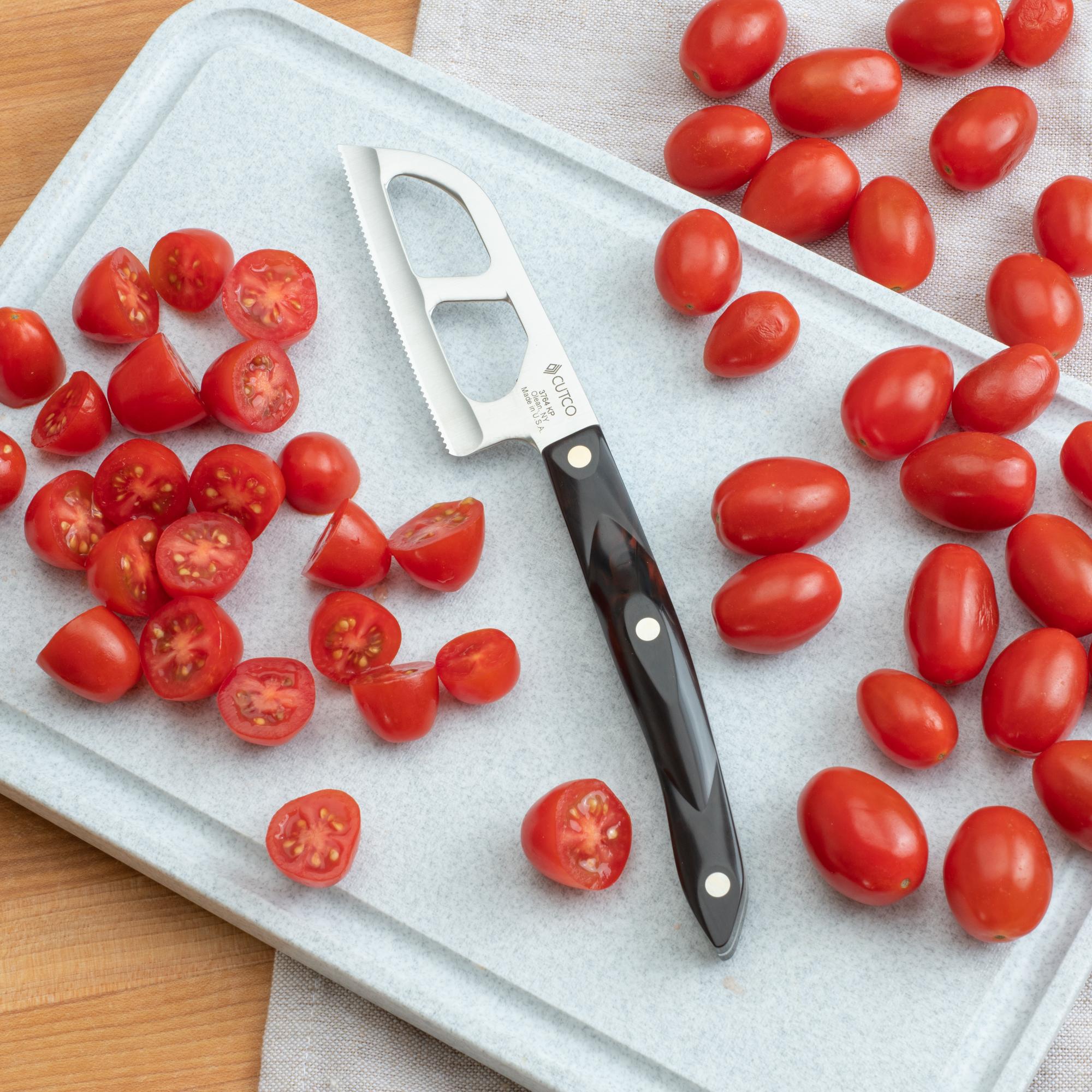 Halving the grape tomatoes with the Santoku-Style Cheese Knife.