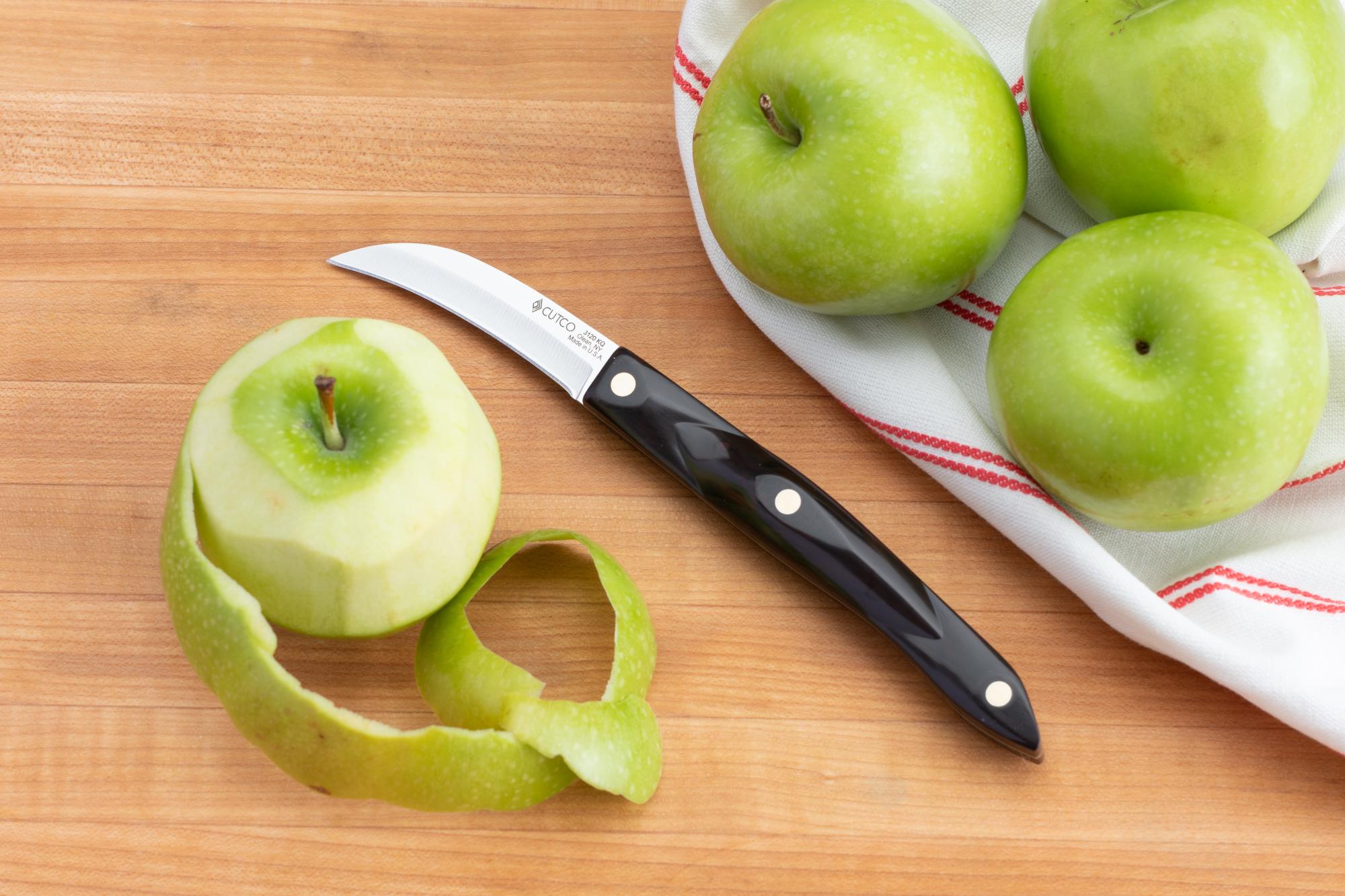Using a Birds Beak Paring Knife to peel the apples.