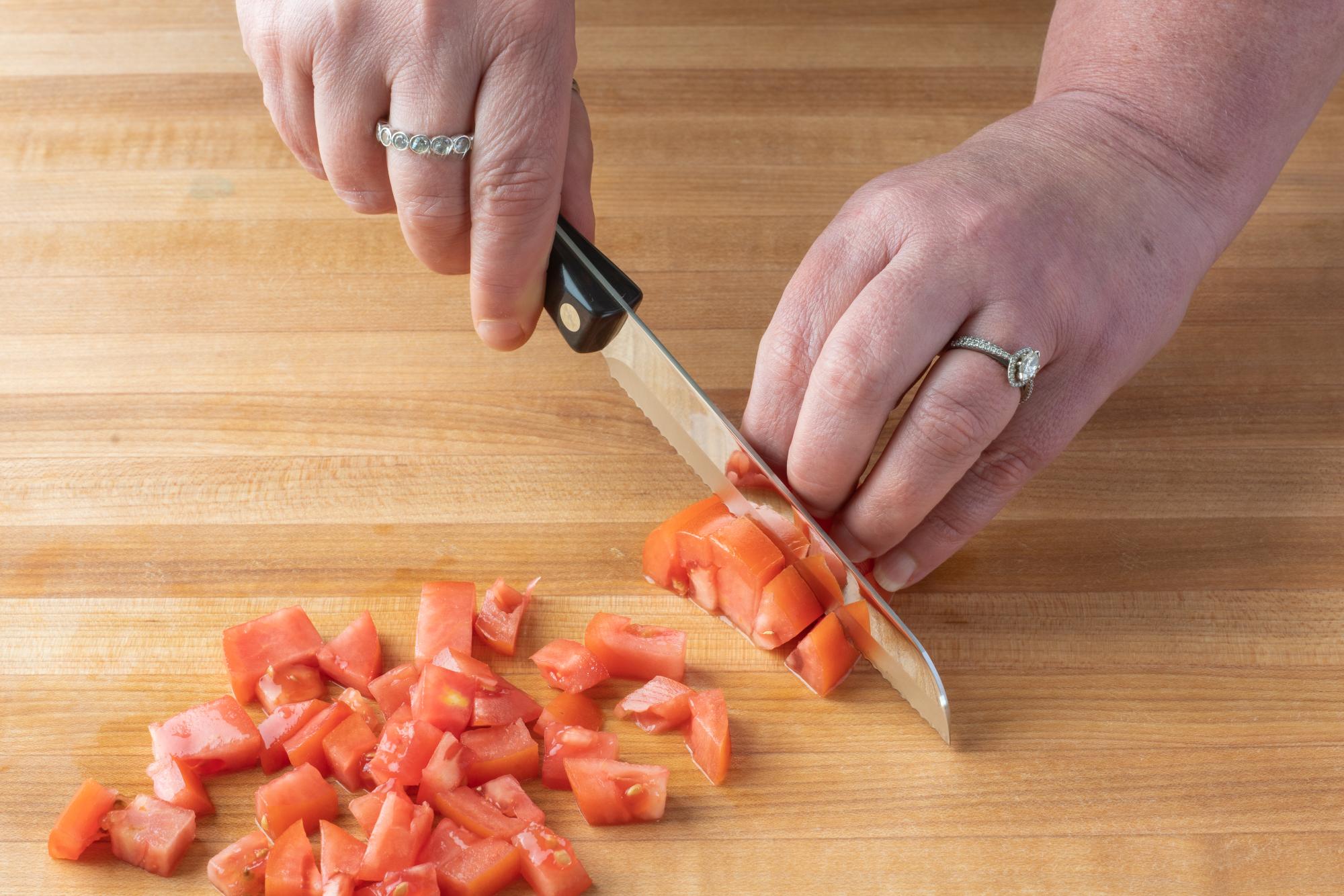 Using a Santoku-Style Trimmer to chop the tomatoes.