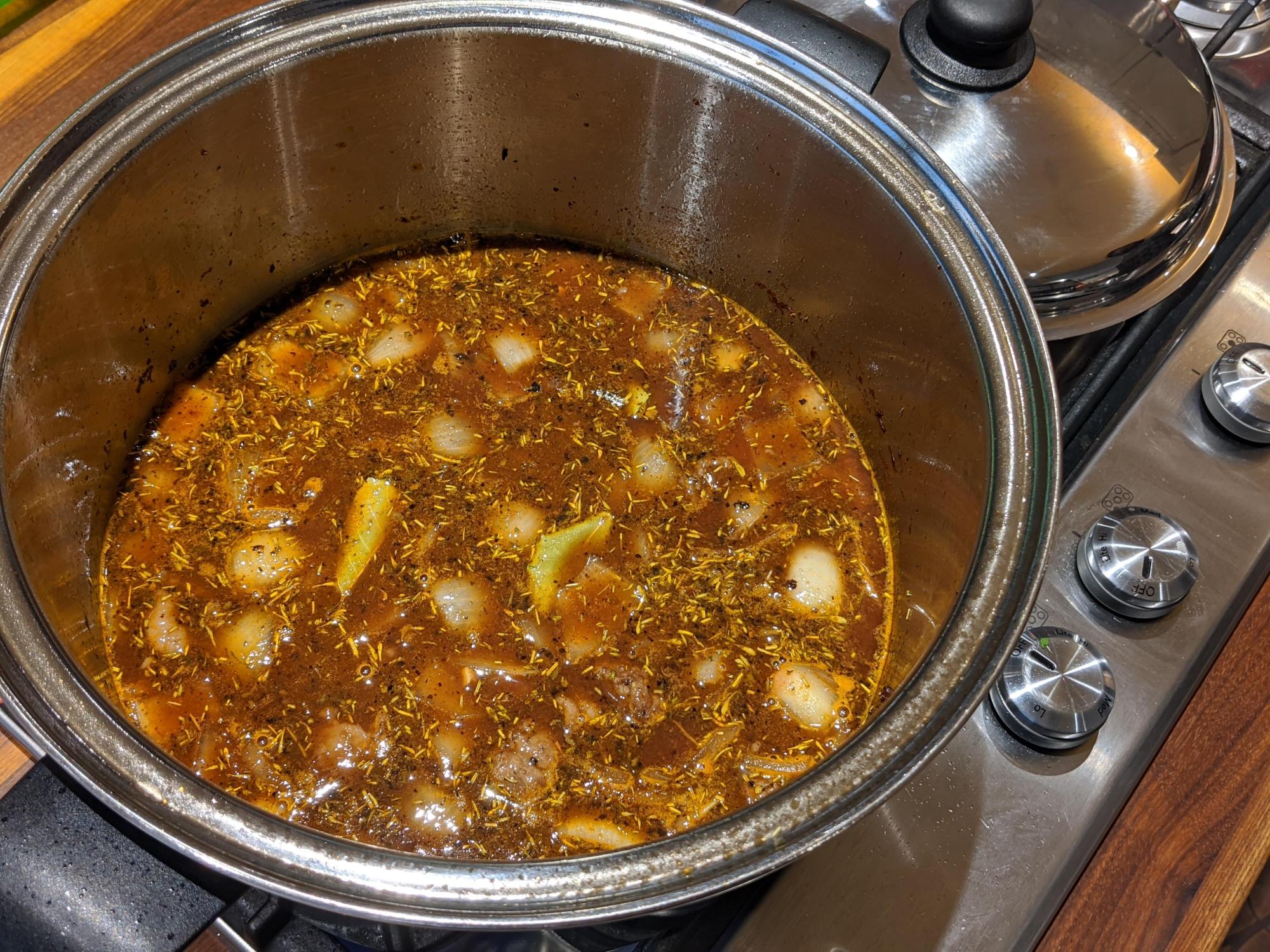 Combined beef stew simmering.