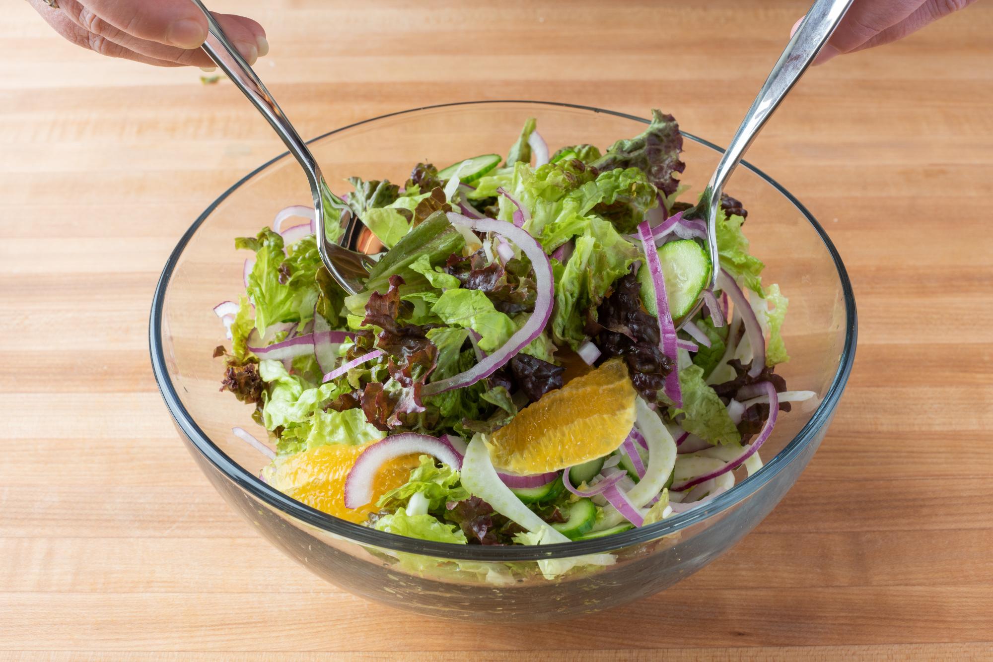 Using Stainless Serving Forks to toss the ingredients together.