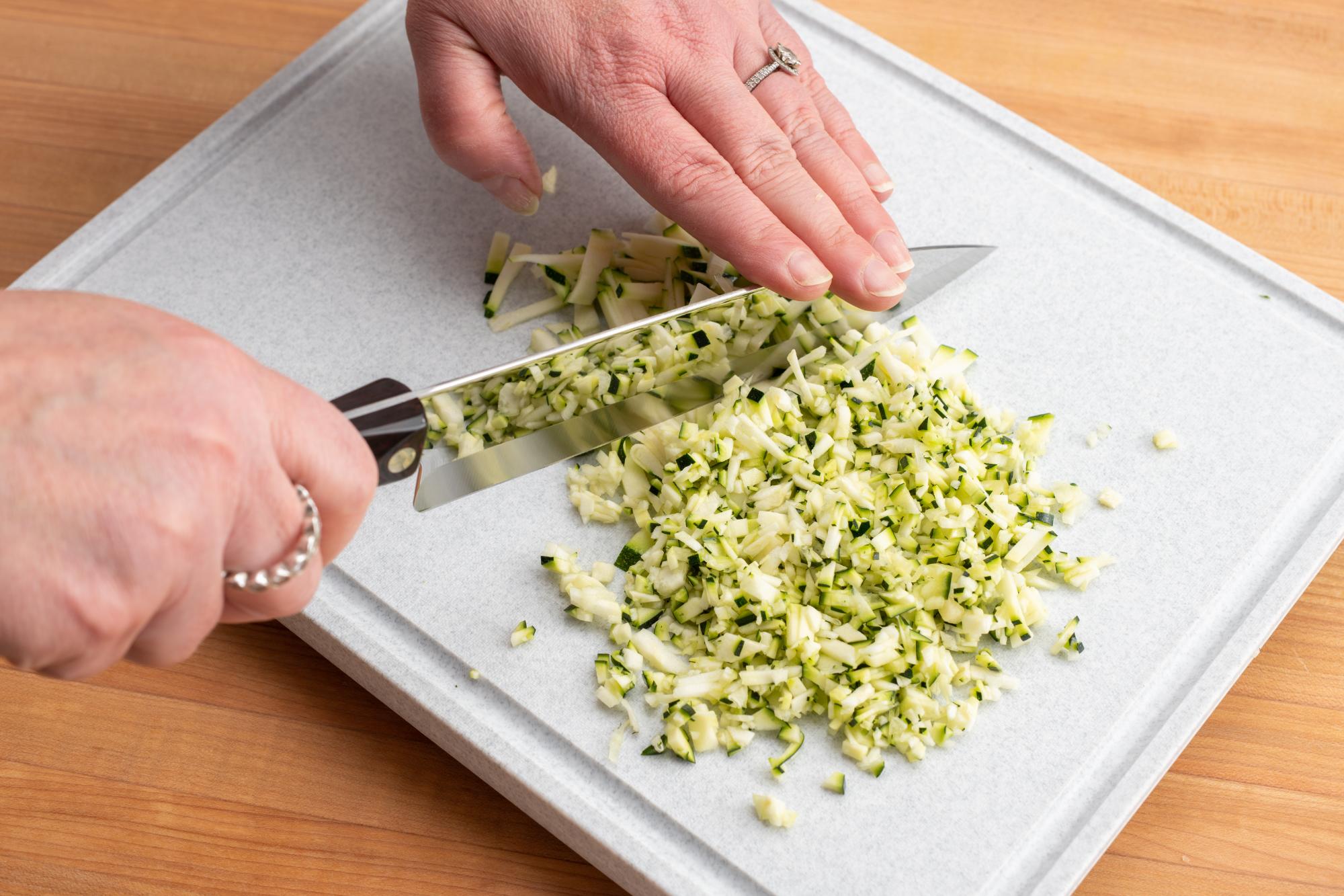 Mincing the zucchini.