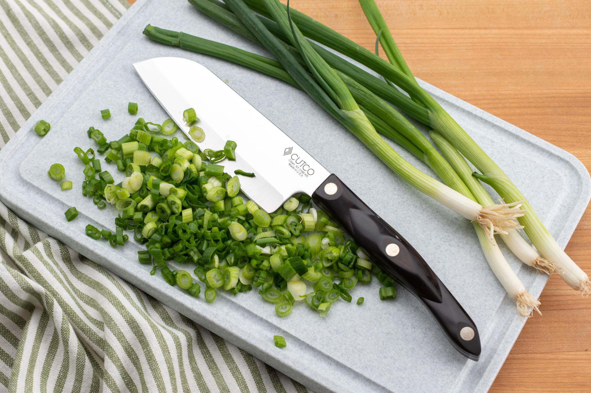 Sliced green onion with a Petite Santoku.