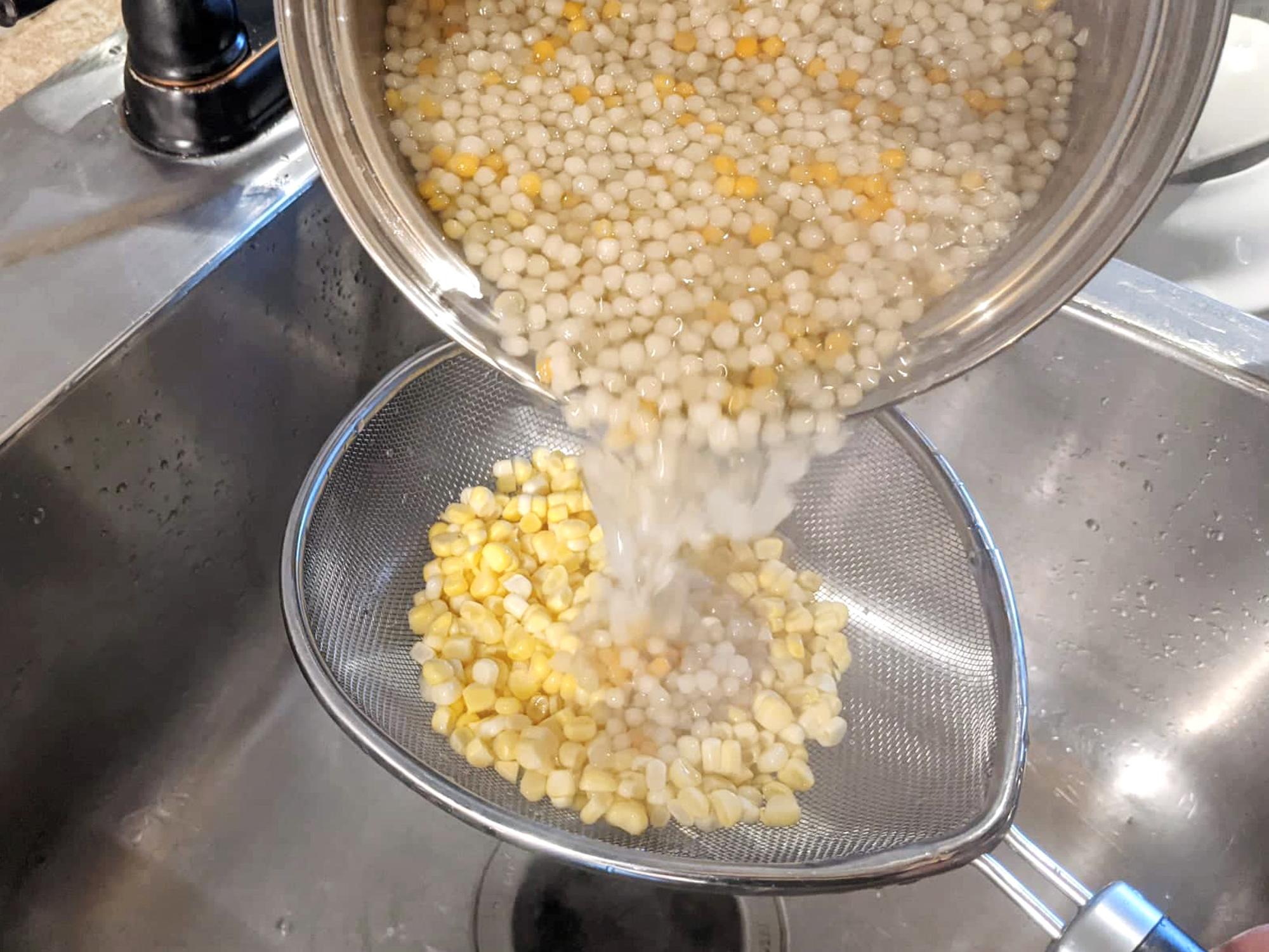 Pouring the hot couscous over the corn.