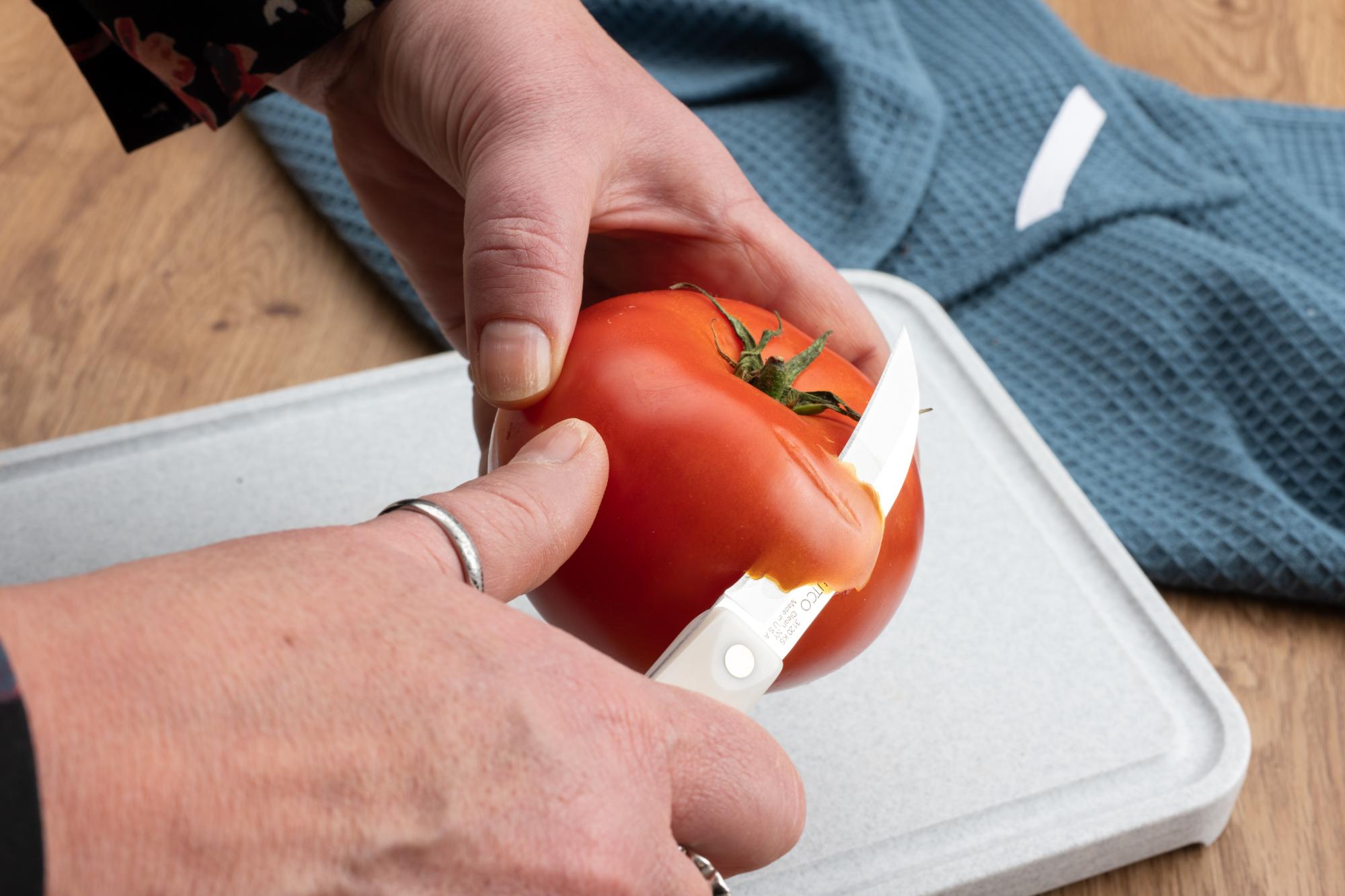 Starting the tomato peel with a Bird's Beak Paring Knife.