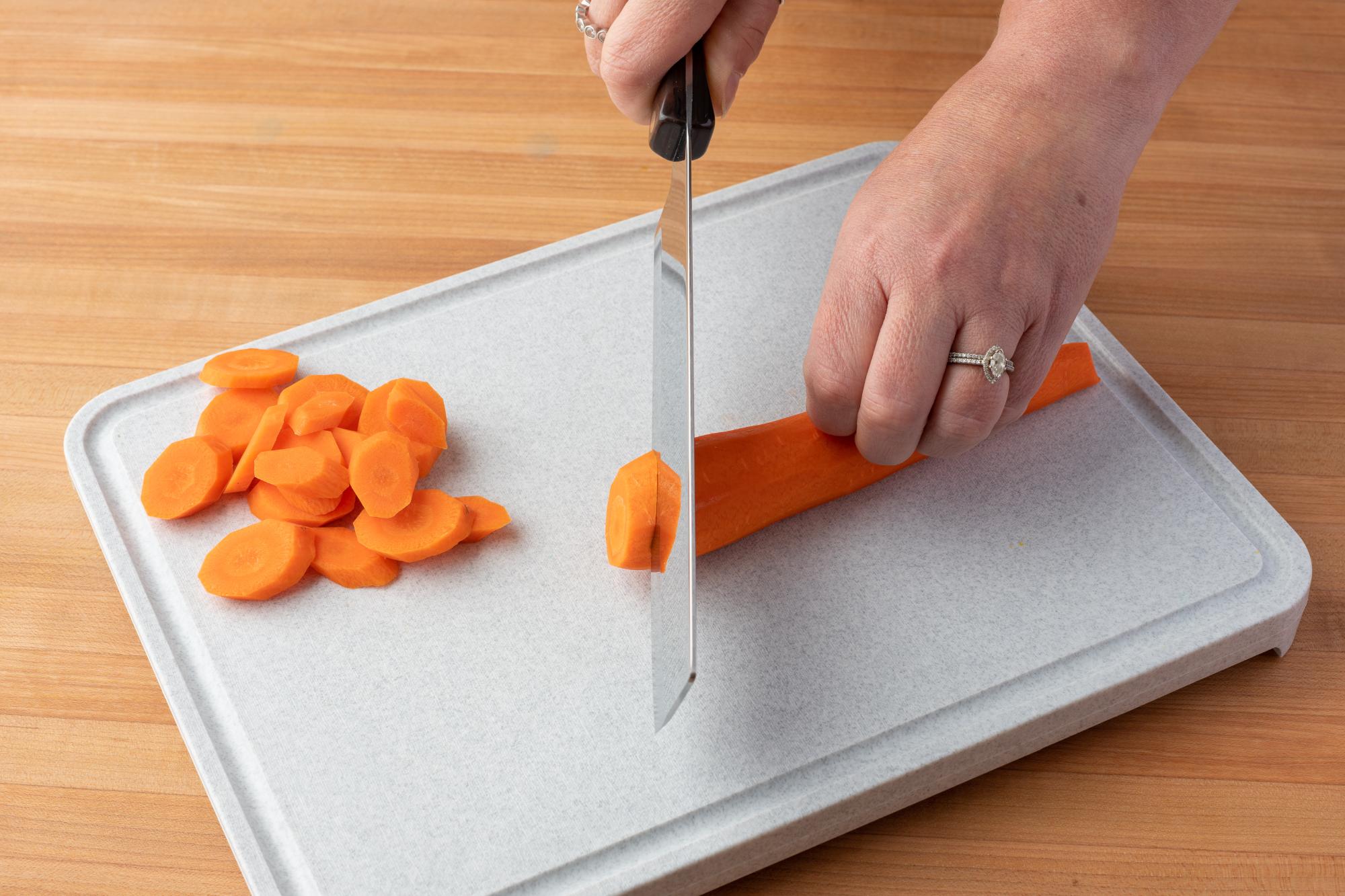 Cutting the carrot on the bias with a Vegetable Knife.