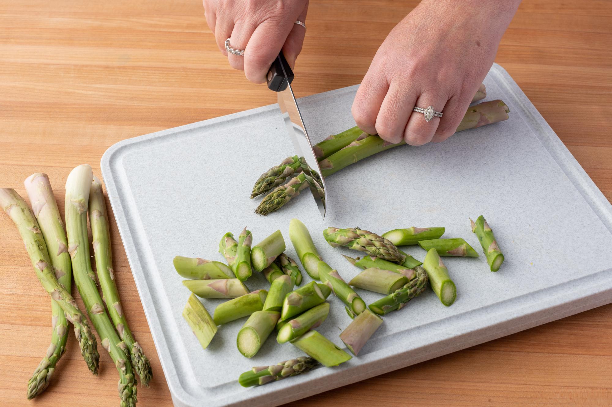 Trimming asparagus with a Santoku-Style Trimmer.