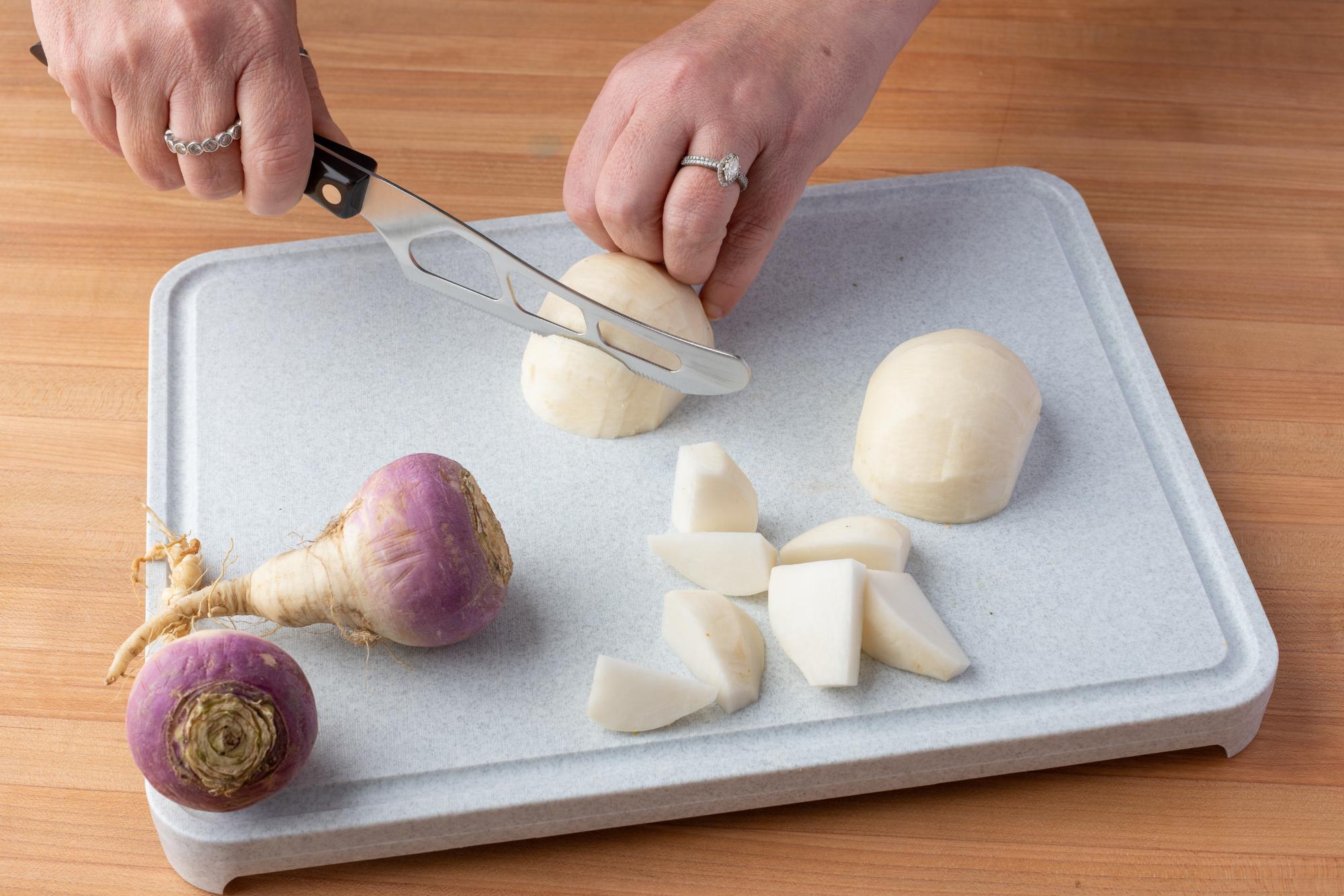 Using a Traditional Cheese Knife to cut the turnips.