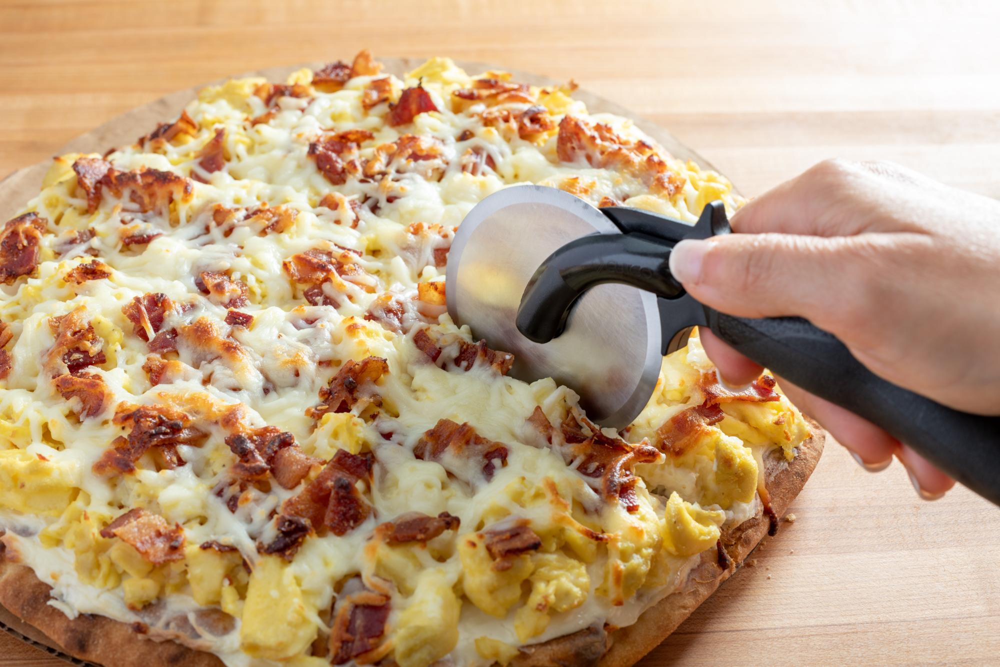 Pizza cutter with pizza.