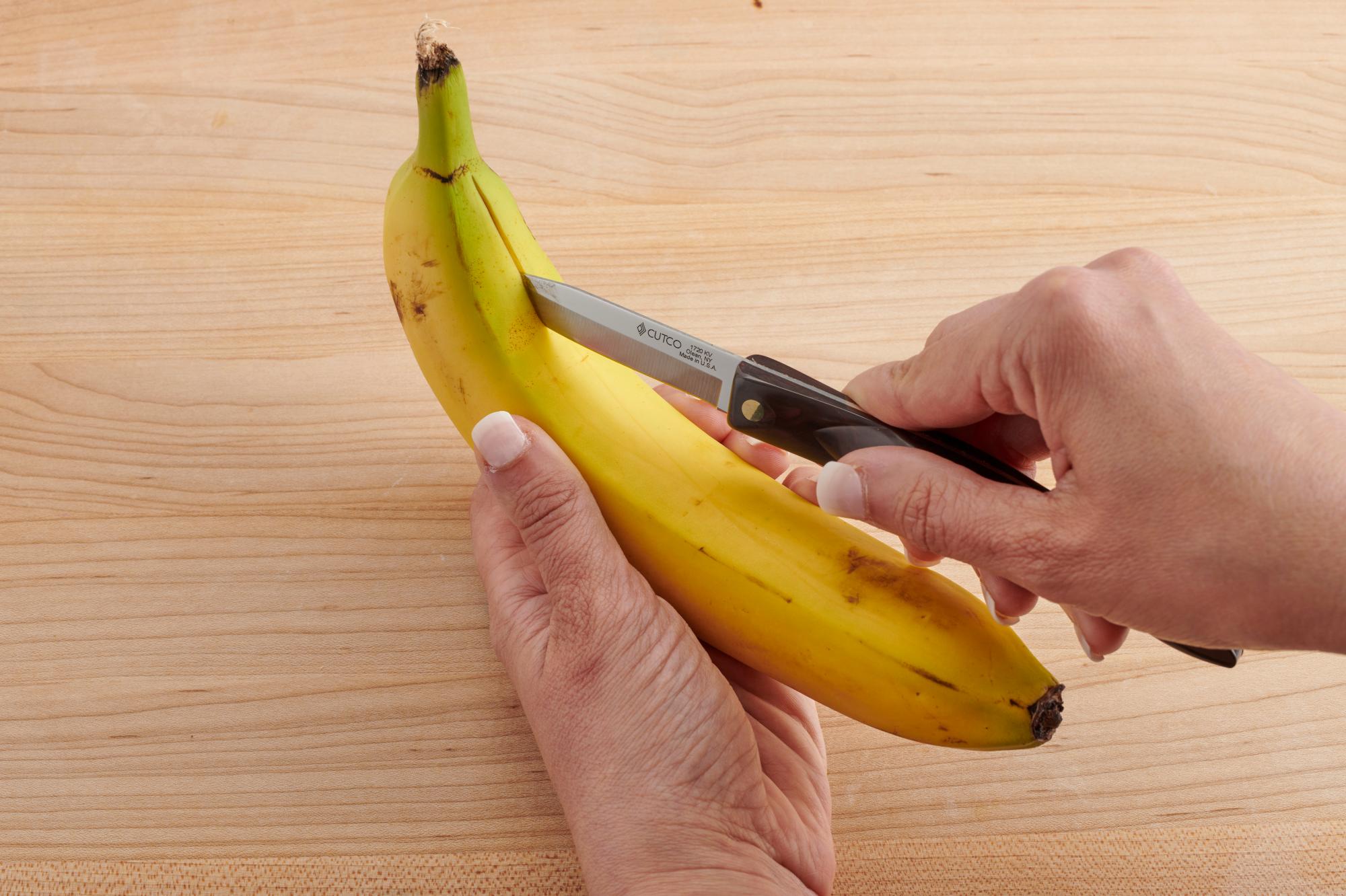 Use the Paring Knife to slice the banana peel.