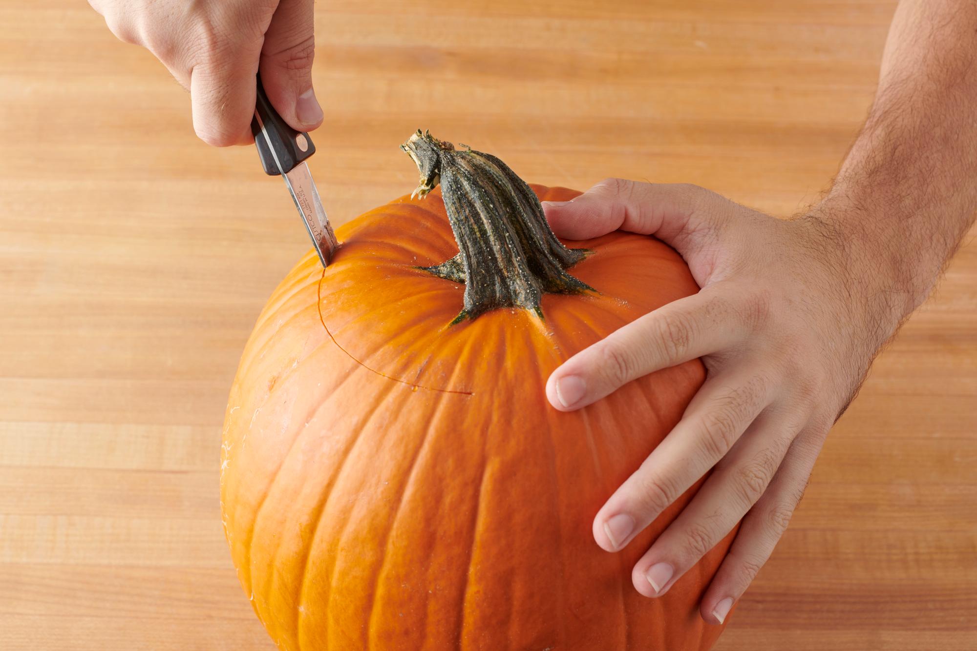 Cutting the top of the pumpkin off with a Trimmer.