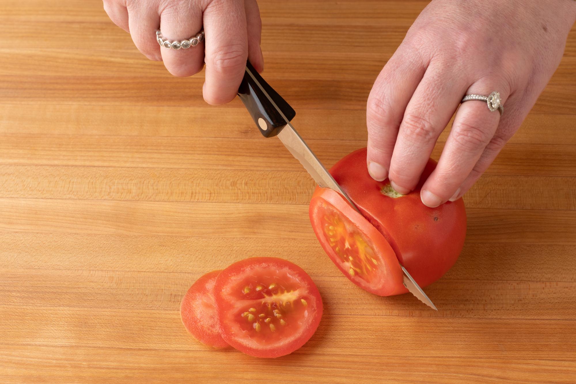 Slicing tomato with a trimmer.