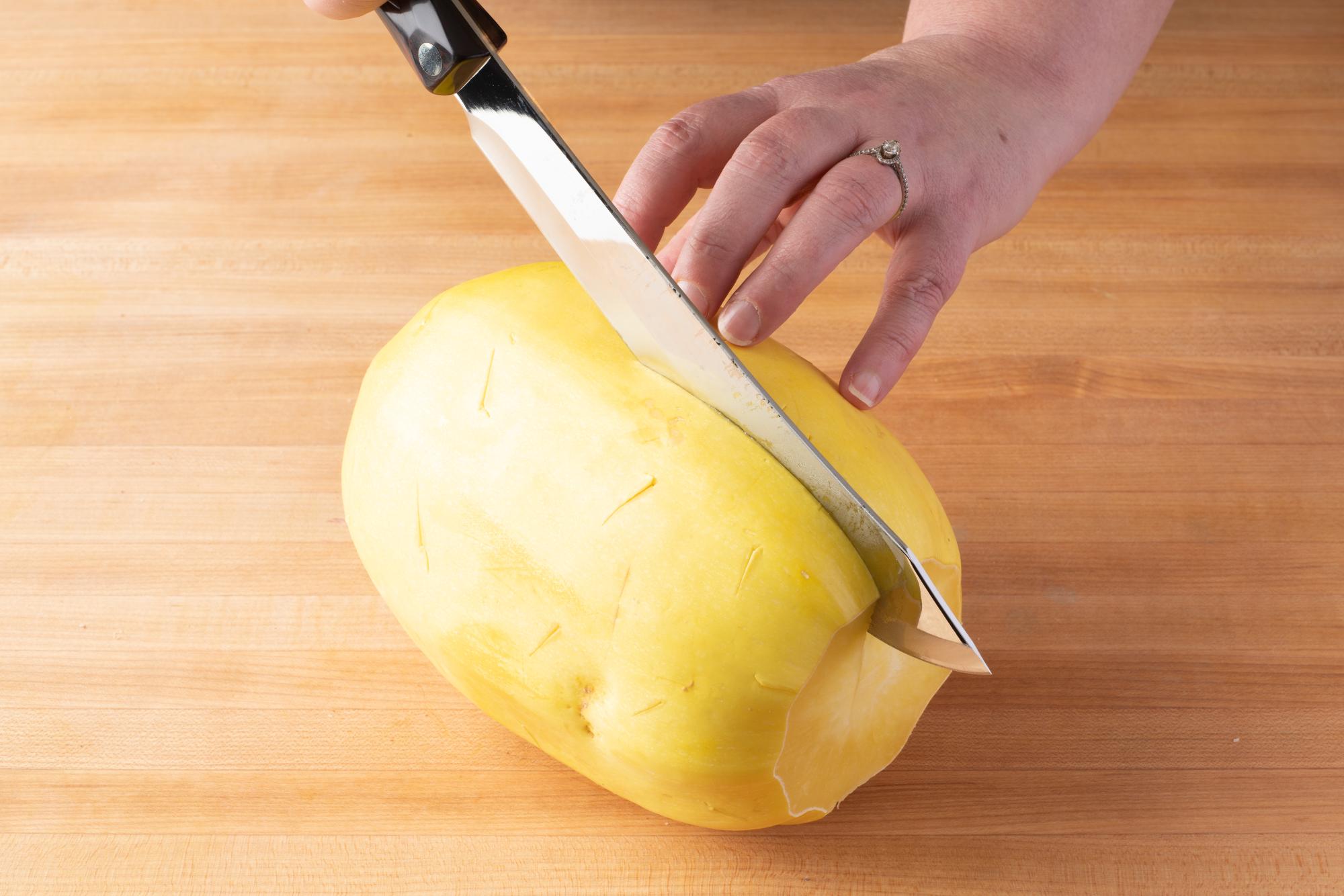Butcher Knife cutting squash in half.