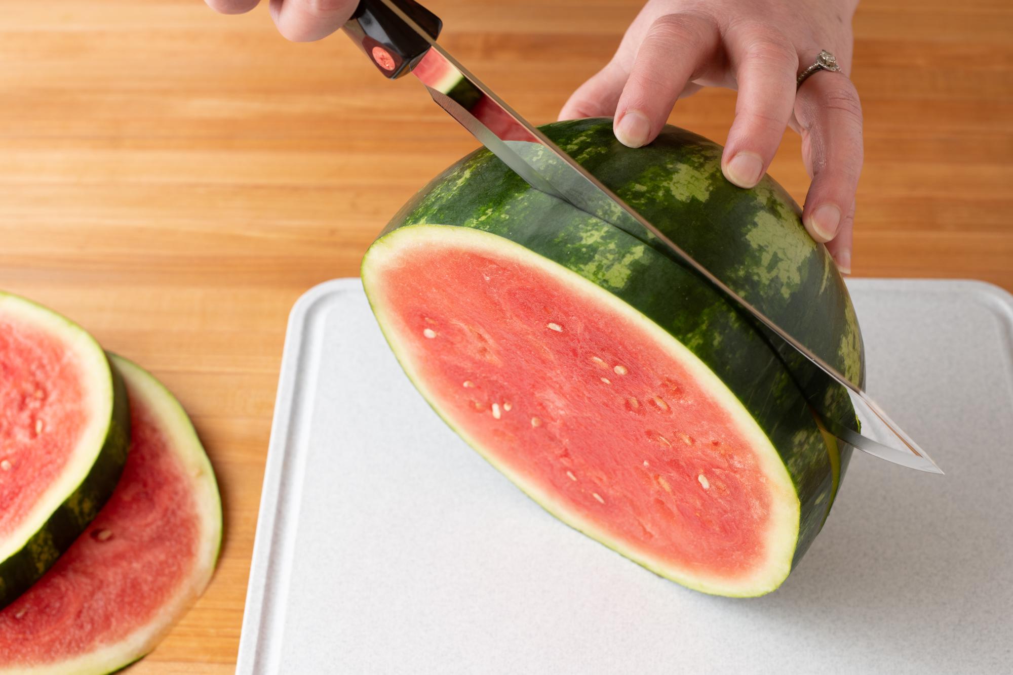 Slicing watermelon with a Butcher Knife.