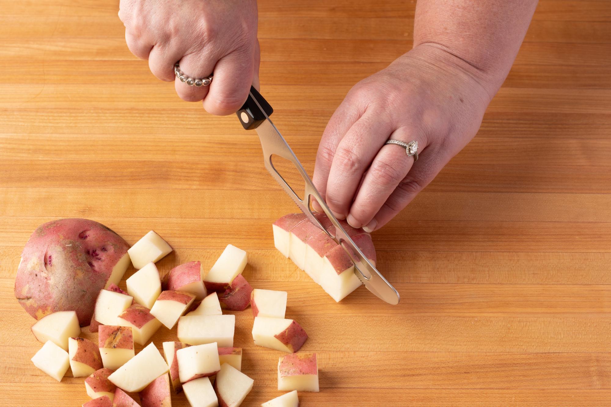 Chop the red potatoes with a Traditional Cheese Knife.