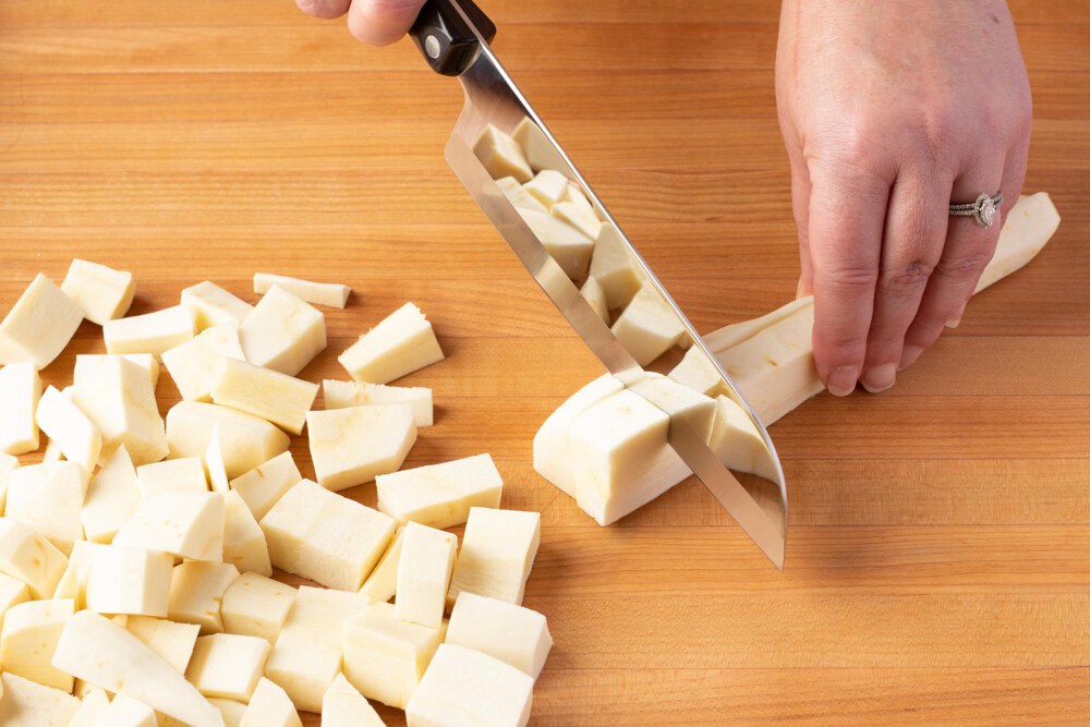 Using a Santoku to cut parsnips.