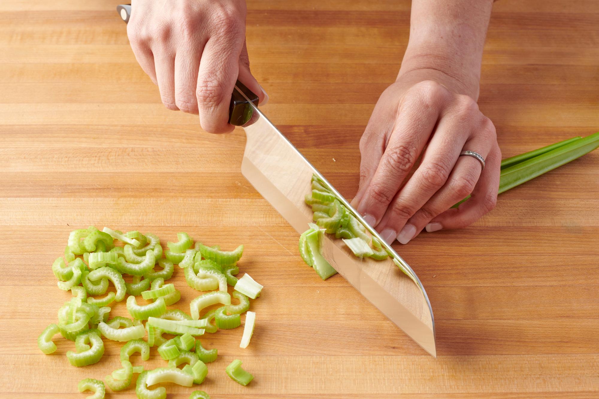 Slicing the celery with a Santoku.